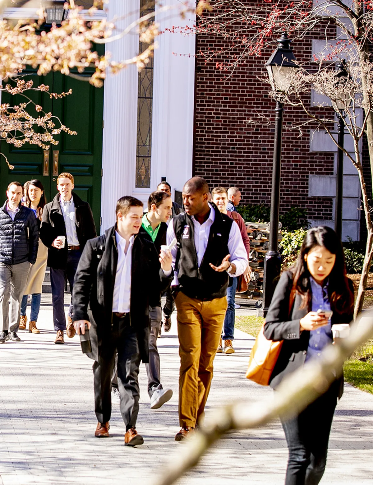 MBA students continue their education walking from the student center to the classroom.