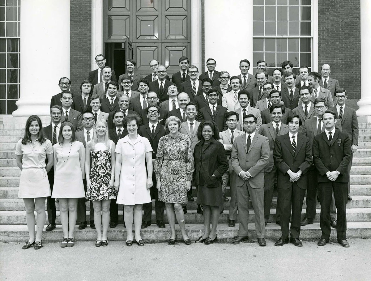 Group of male and female International Teachers Program students posing on the steps of Baker Library.