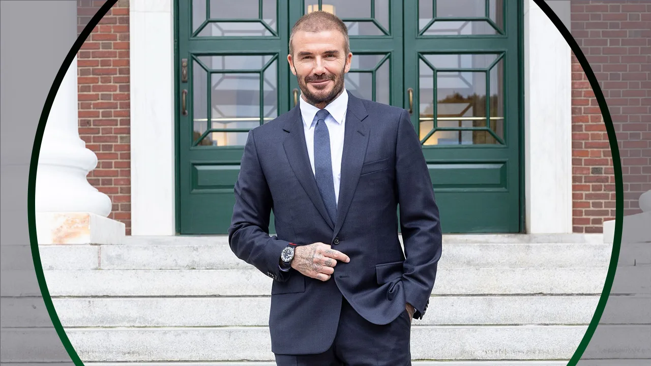 David Beckham wearing a suit in front of a green door