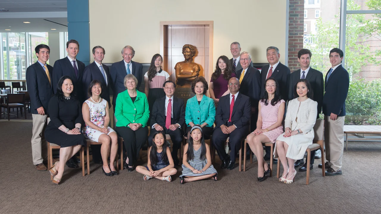 Dr. Chao, daughters and their families with Harvard University President Drew Faust and HBS Dean Nitin Nohria posing for a group photo inside Chao Center