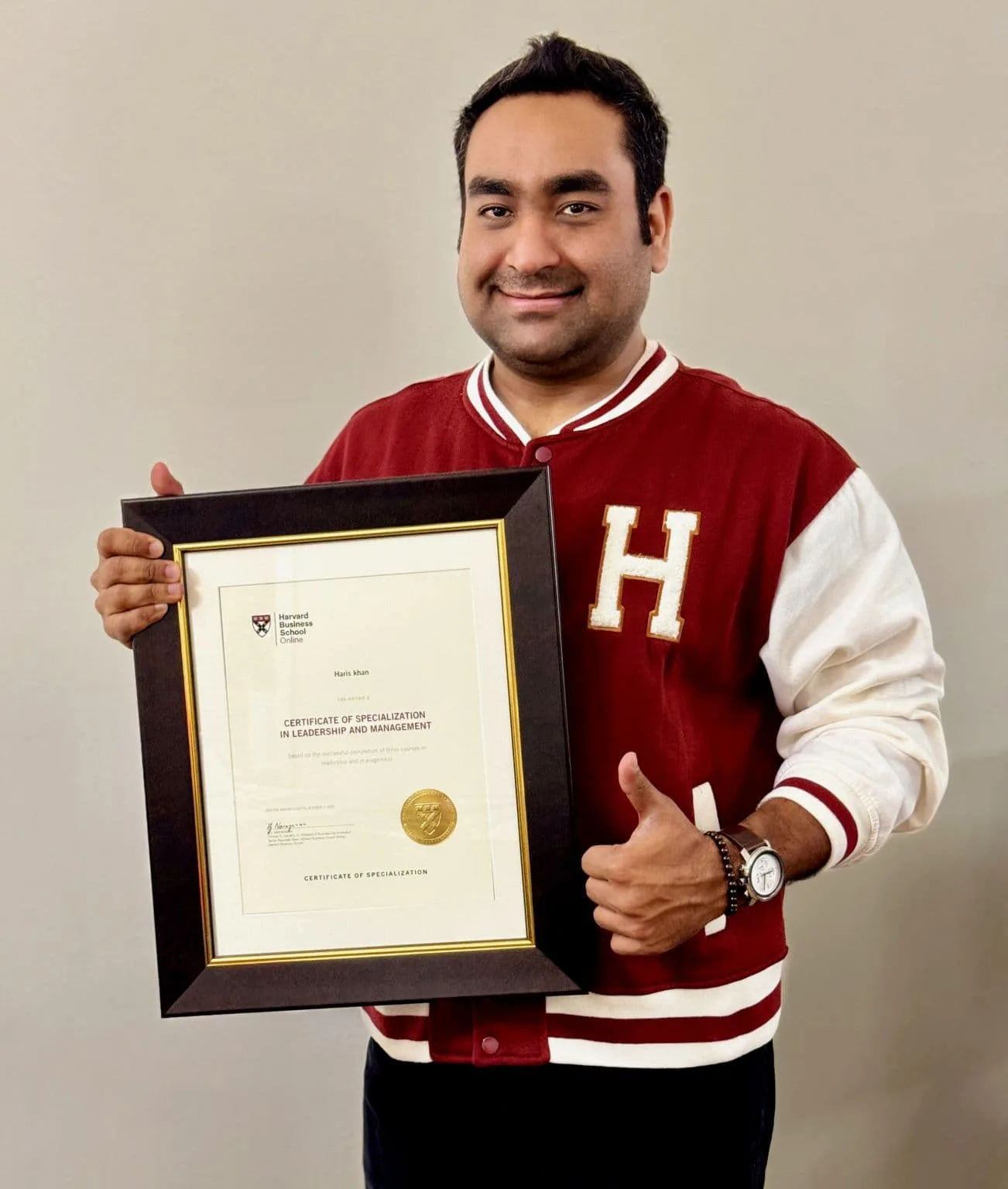 Haris Khan holding certificate