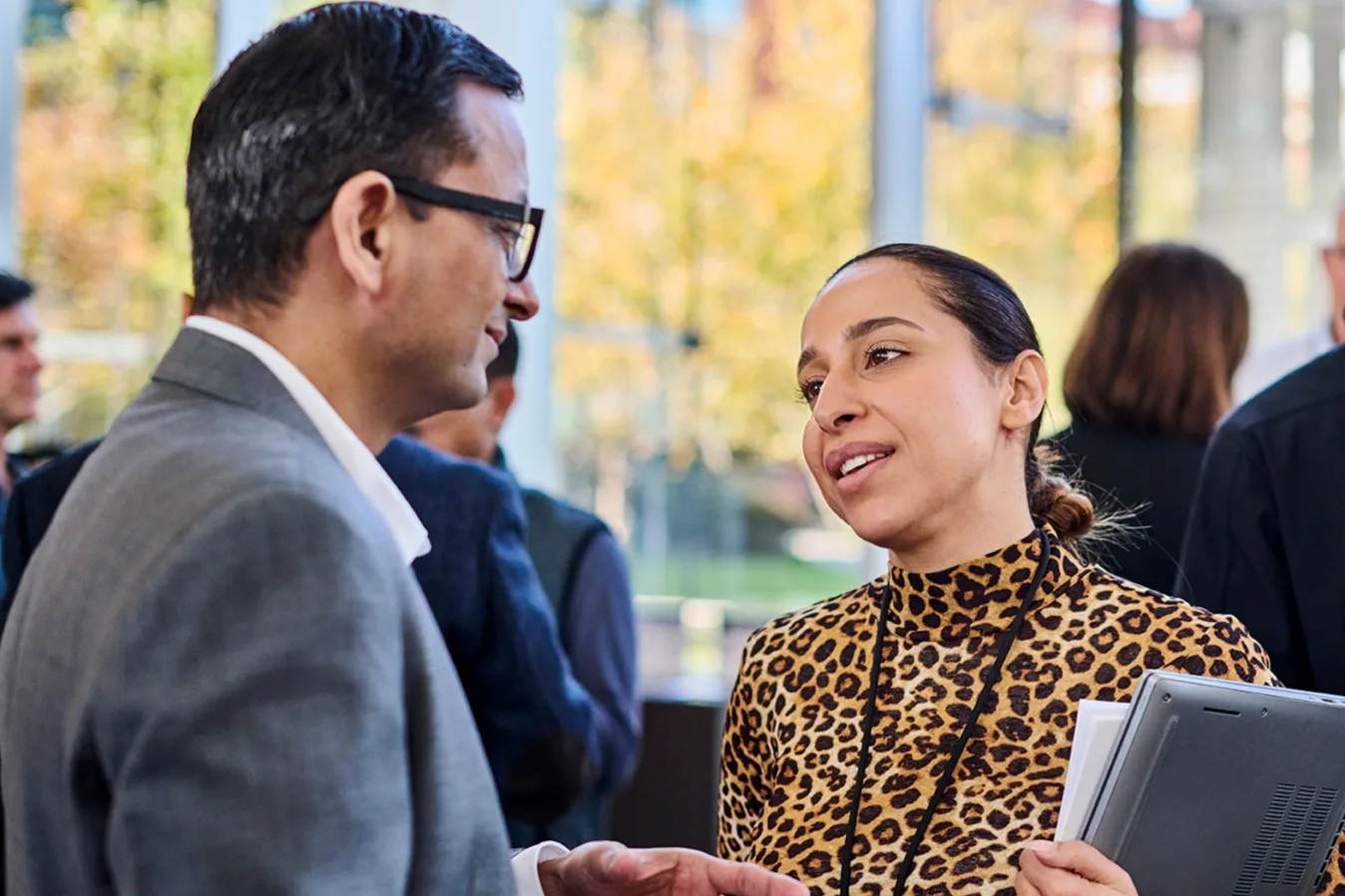 A male and female participating executive discuss a case study outside of the classroom