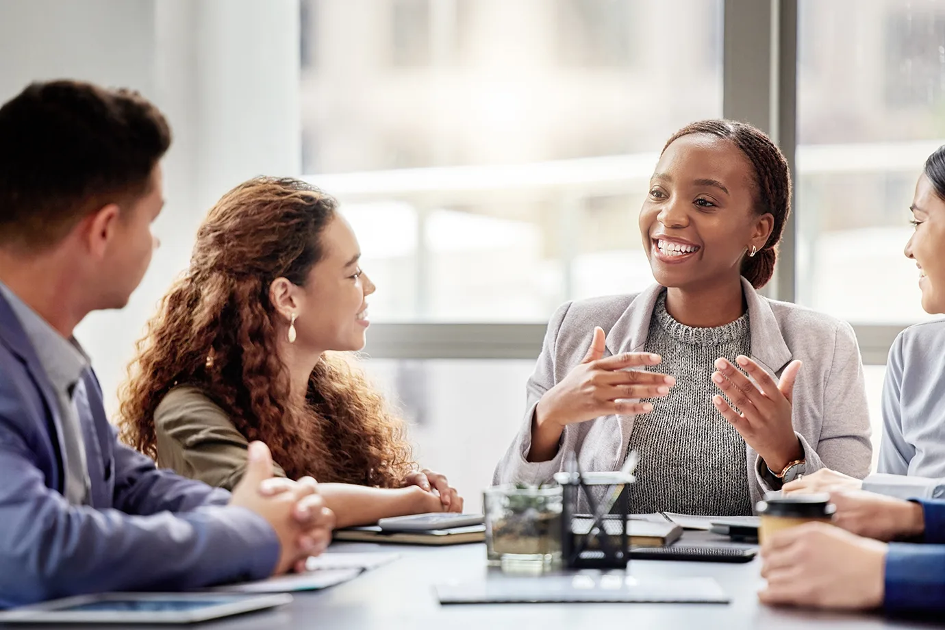 Professionals engaged in a collaborative business discussion during a team meeting in a modern office.
