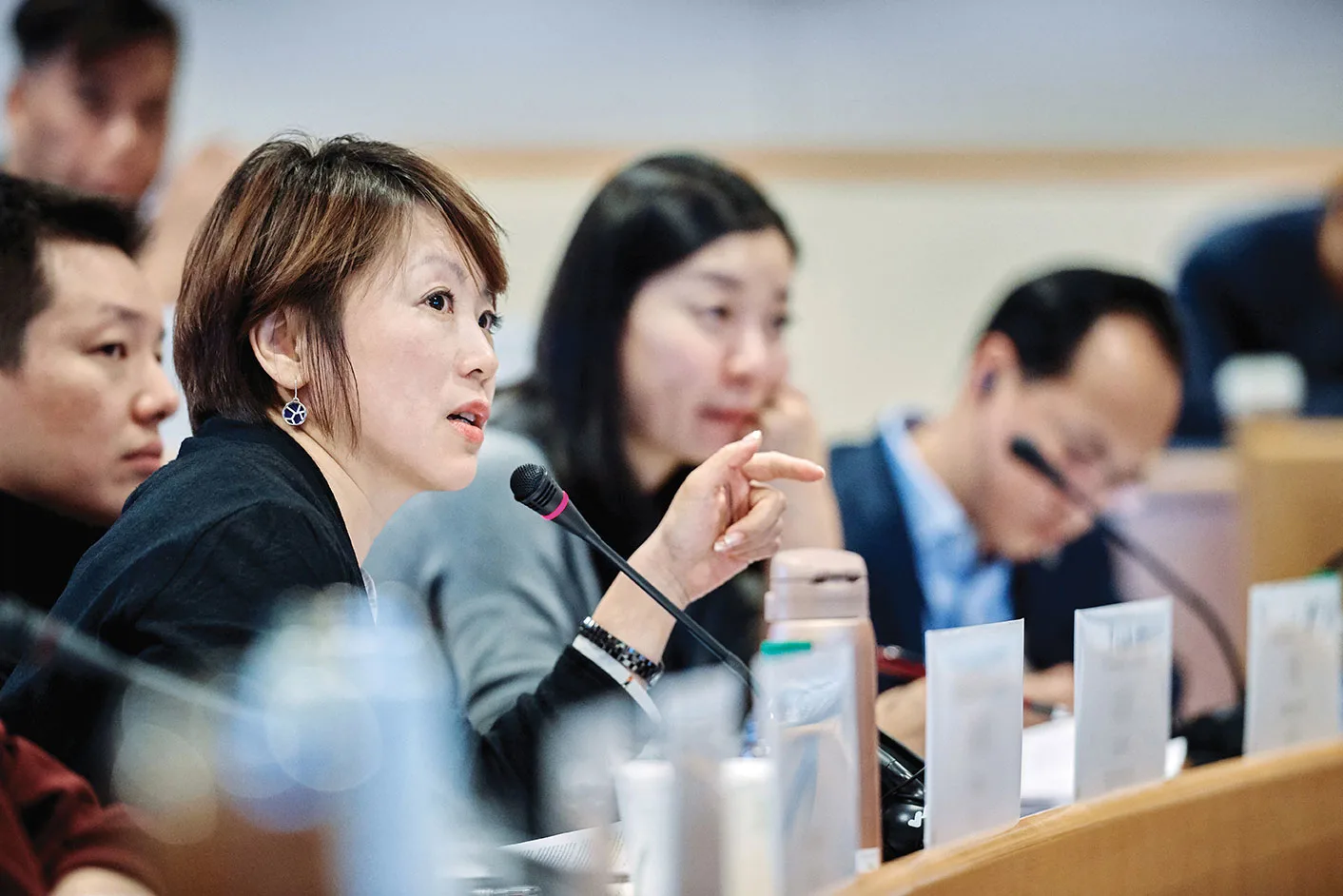 Female executive asking a question during the class