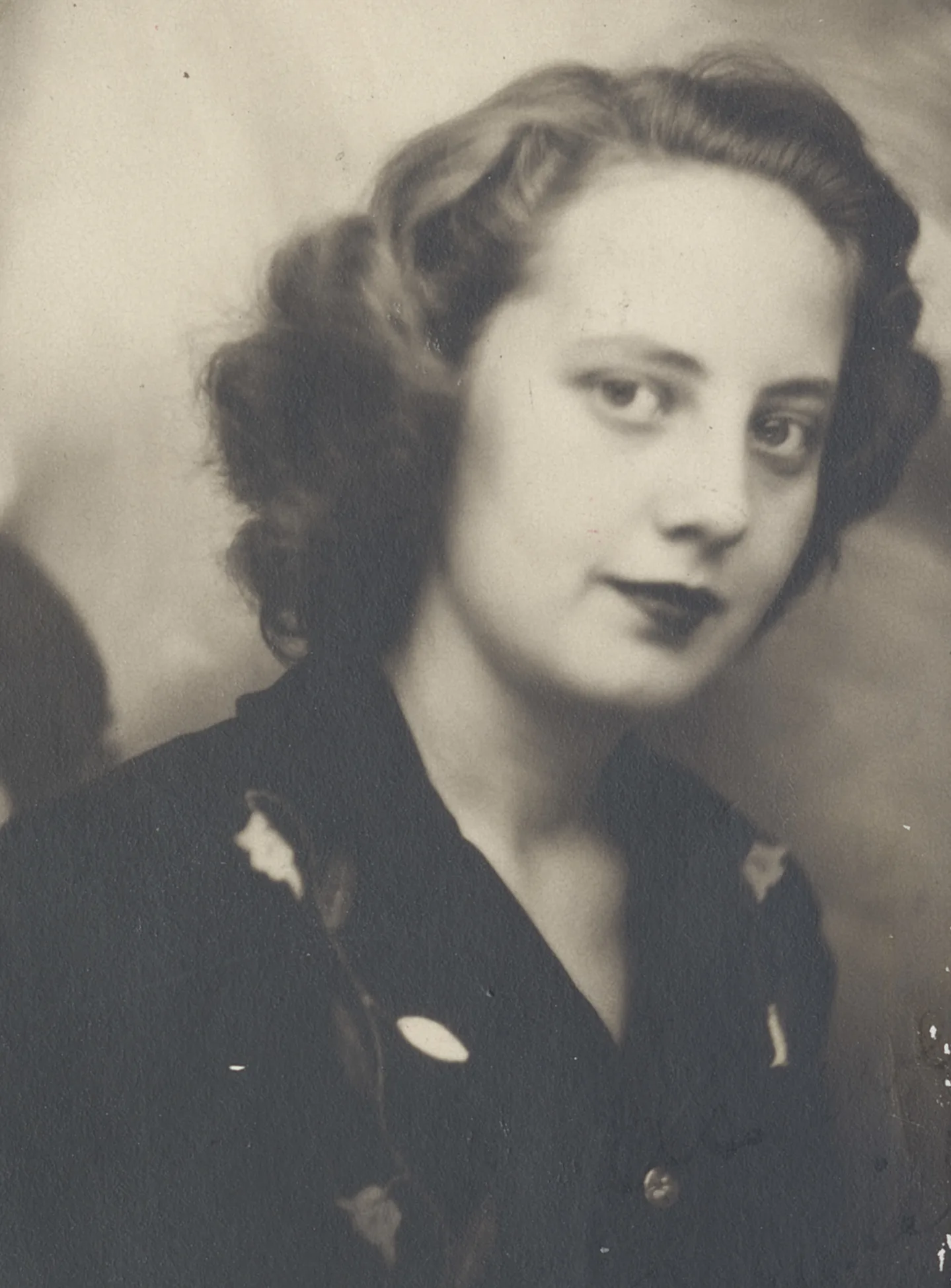Vintage portrait of a young Muriel Siebert with curled hair, wearing a dark dress, 1943