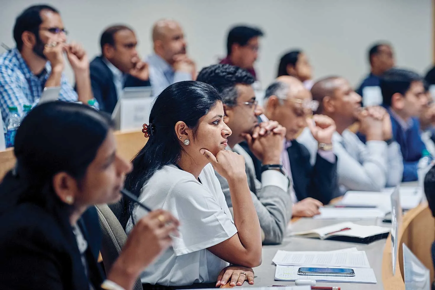 Diverse group of executive concentrated on the lecture in the classroom