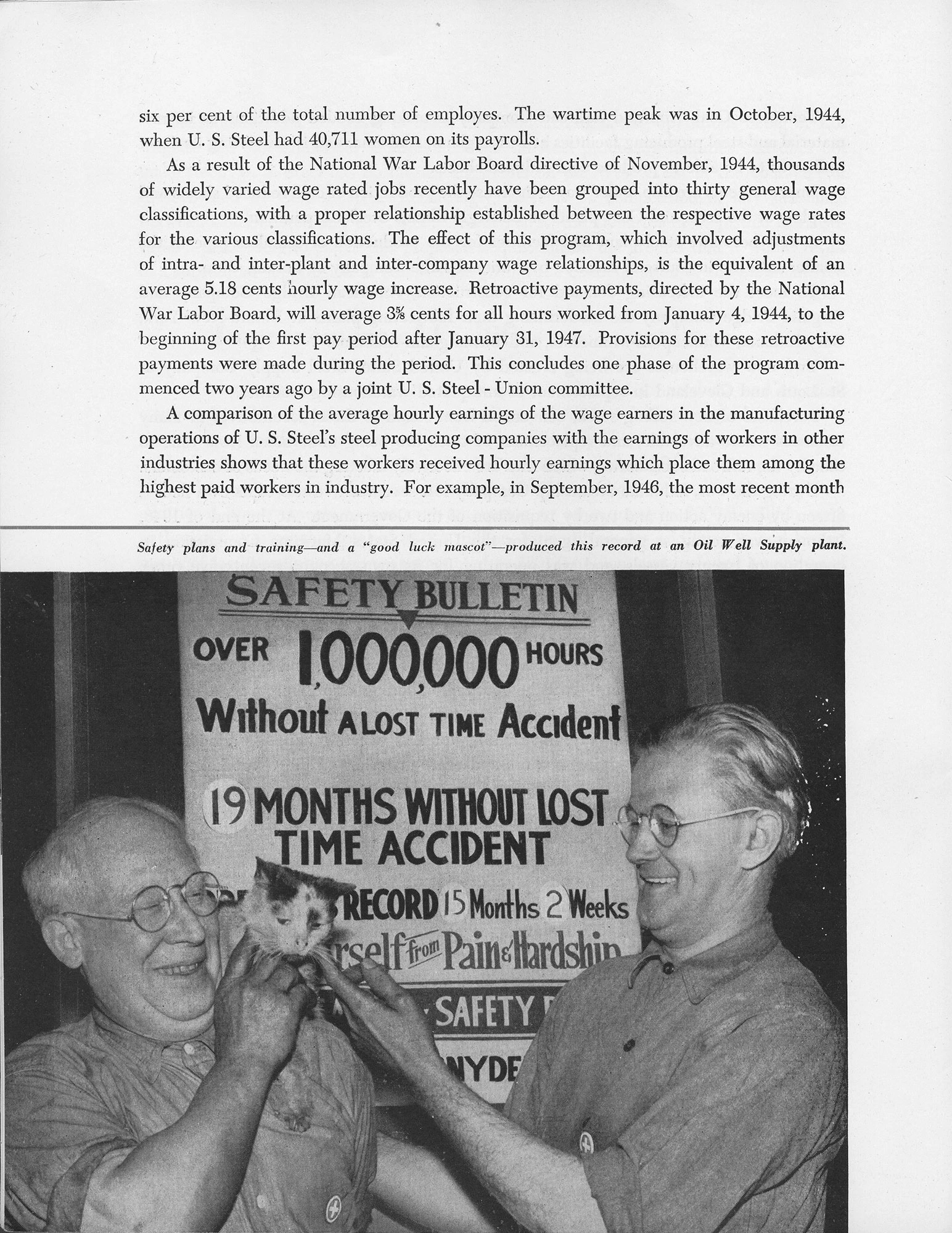 Two smiling workers hold a cat in front of a safety bulletin celebrating over one million hours without a lost-time accident.