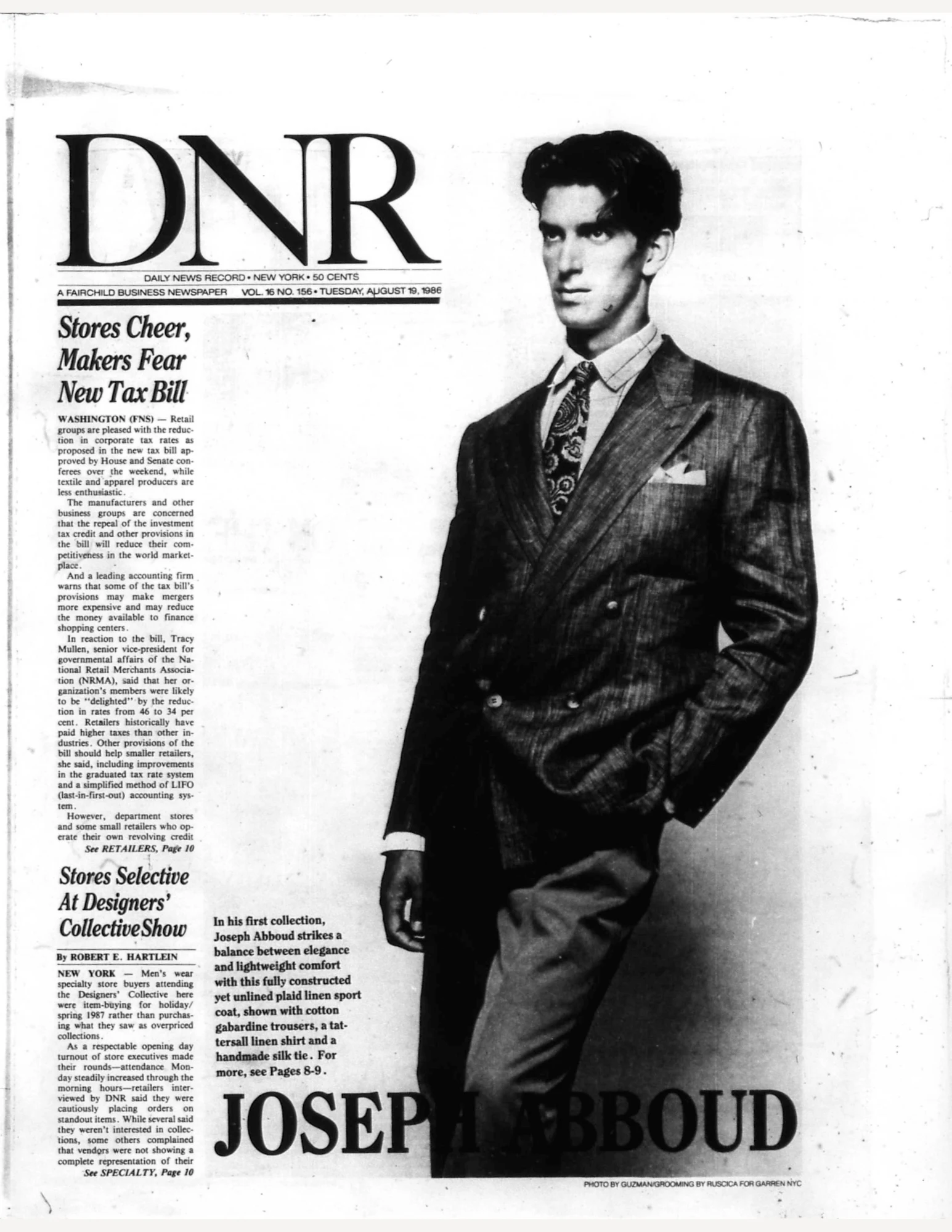 Joseph Abboud on the cover of DNR magazine. He is wearing a suit and tie with one hand in his pant pocket.