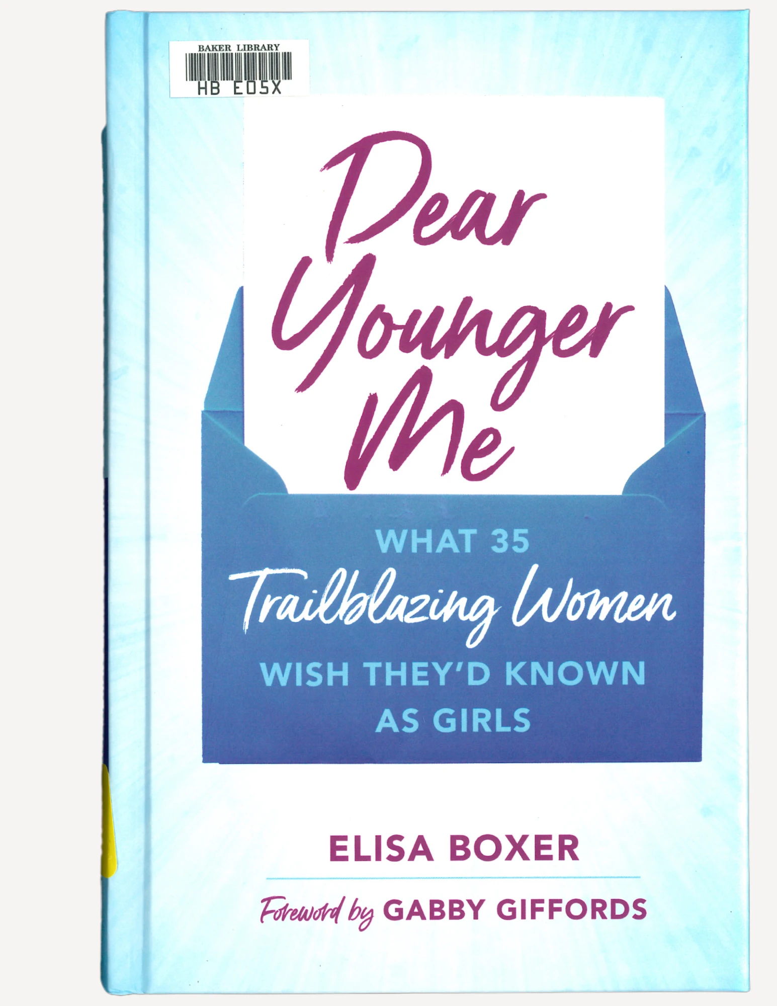 The book cover for "Dear Younger Me". It is a blue envelope opening to a letter that contains the book's title, written in purple script.