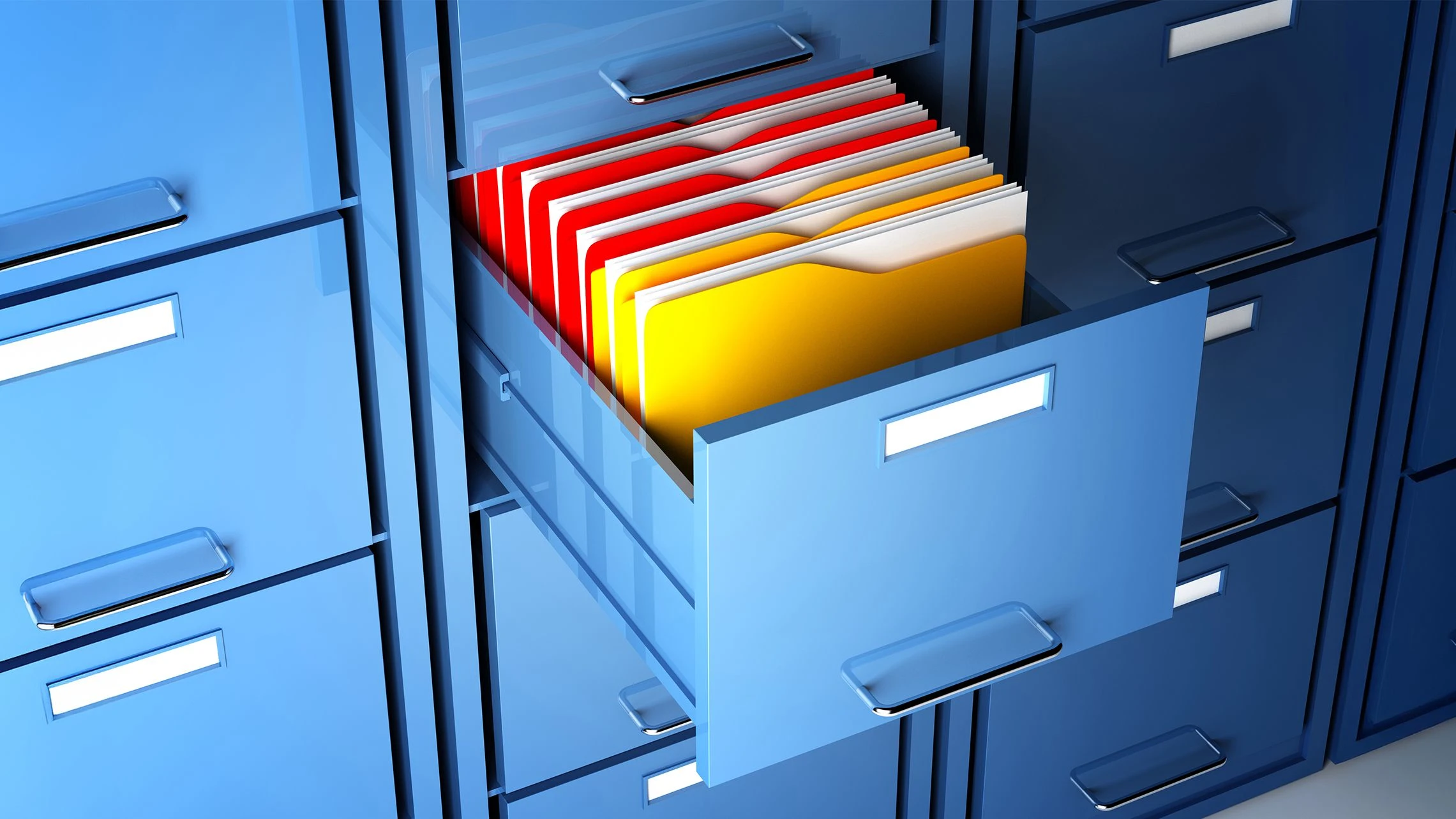 A file cabinet drawer, open to reveal brightly colored files