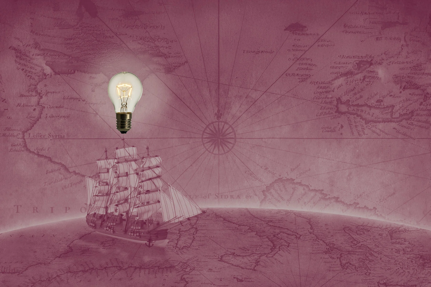 Lightbulb over ship on an old fashioned map.