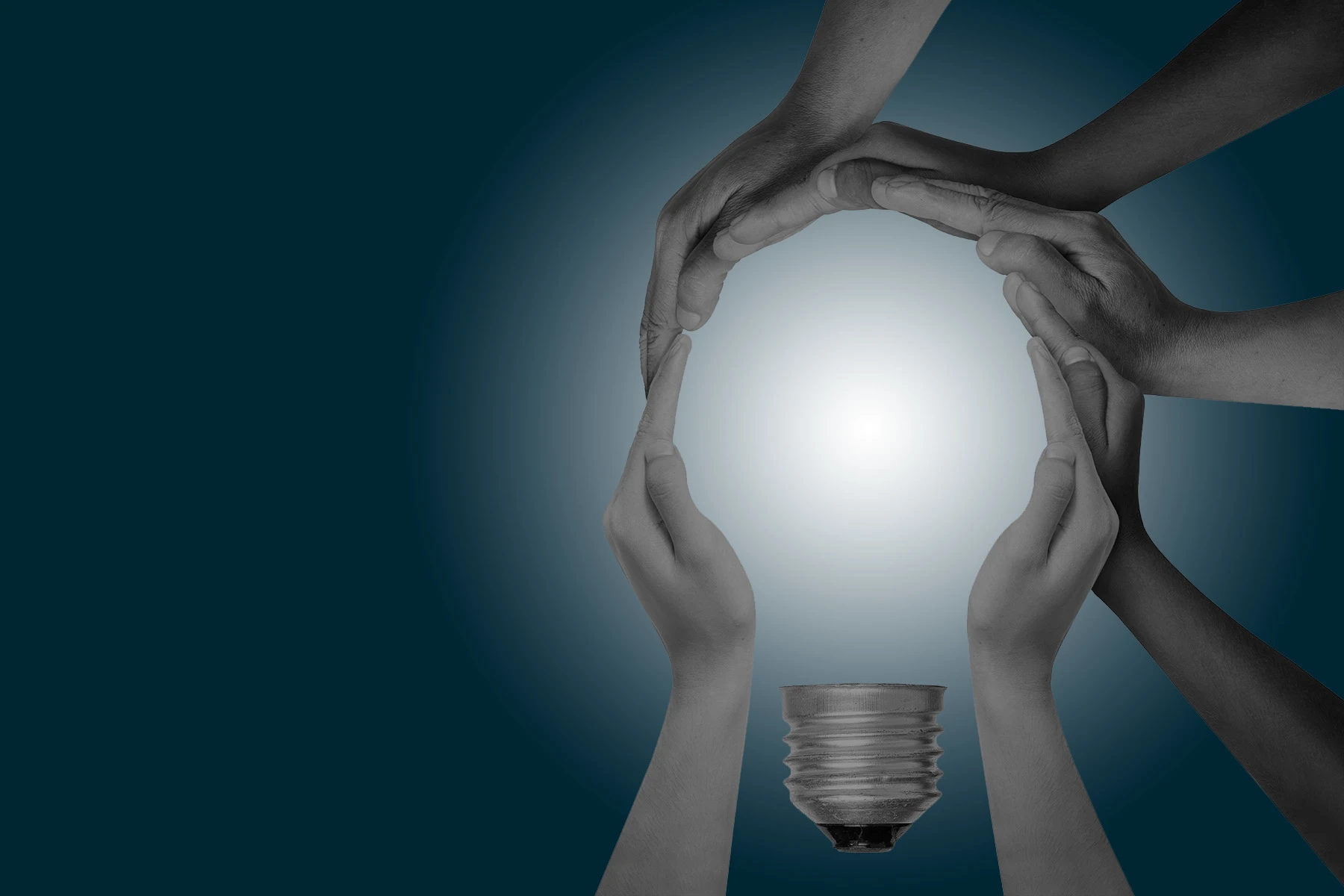 lamp surrounded by hands