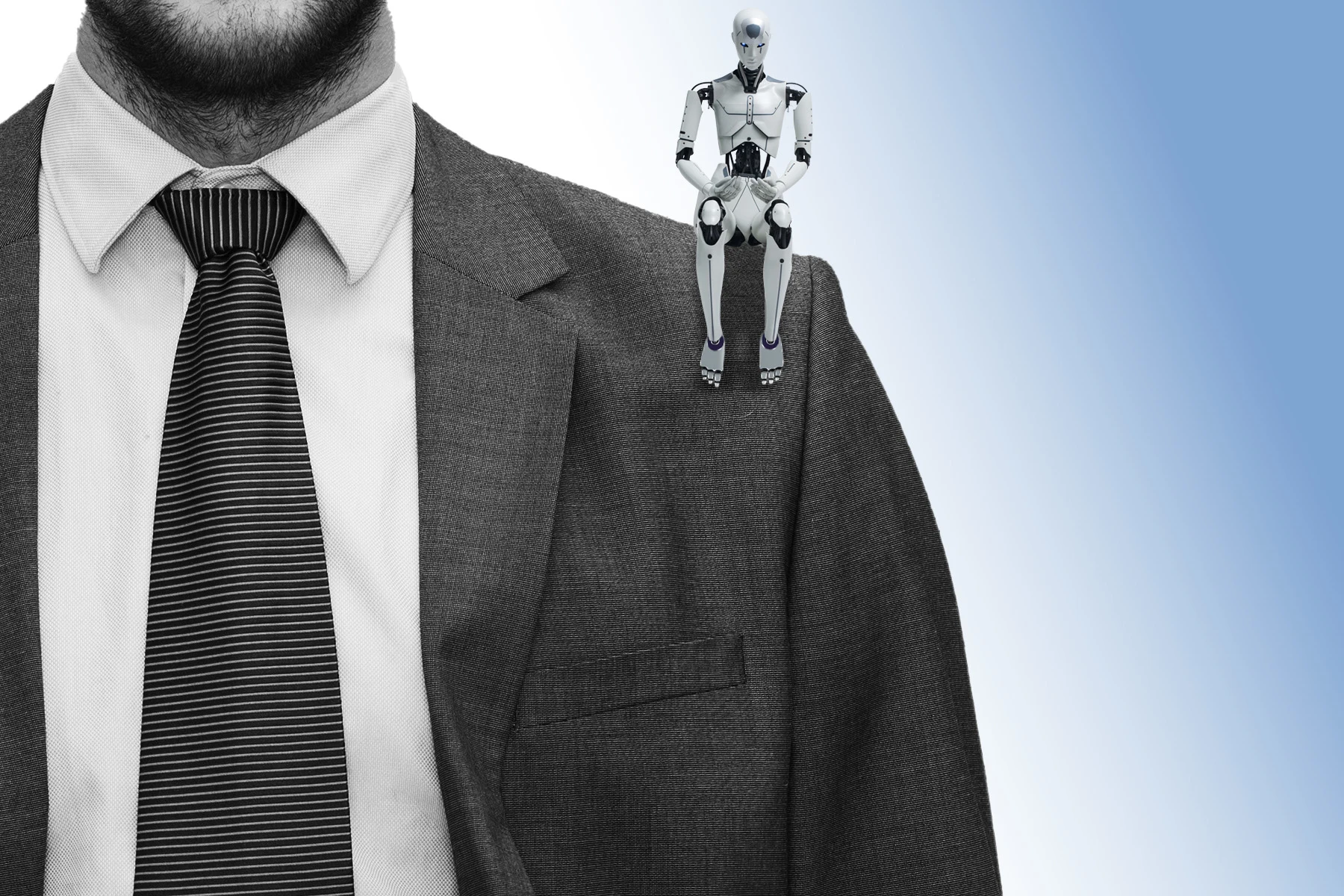 Robot seated on shoulder of person wearing suit.