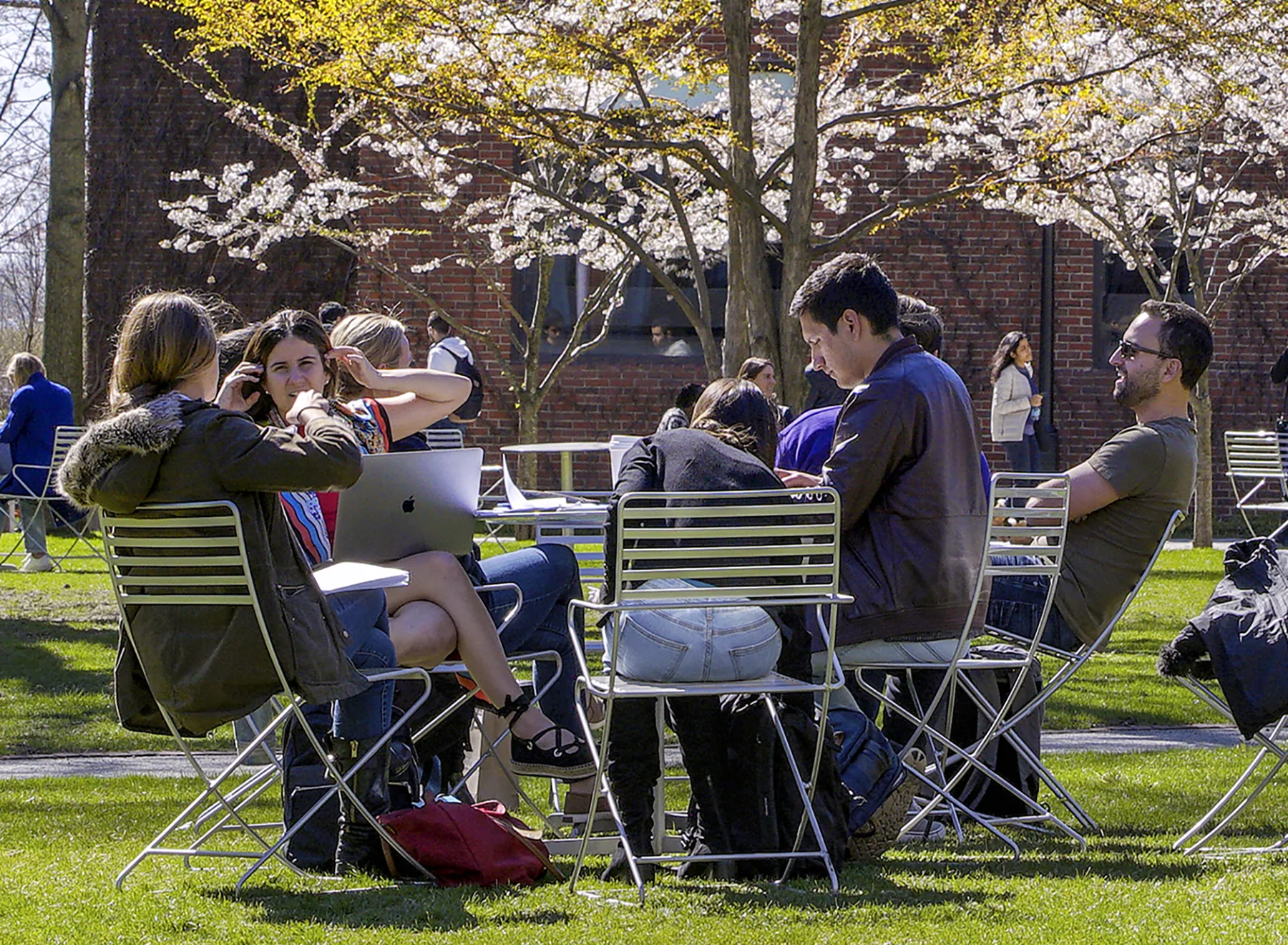 Students continue the discussion on the Harvard Business School campus.