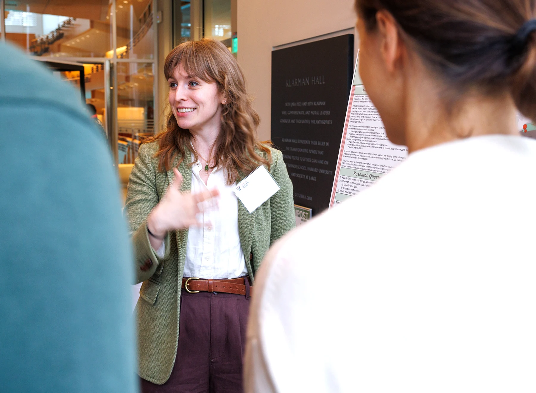 A doctoral student explains her research to members of the faculty.