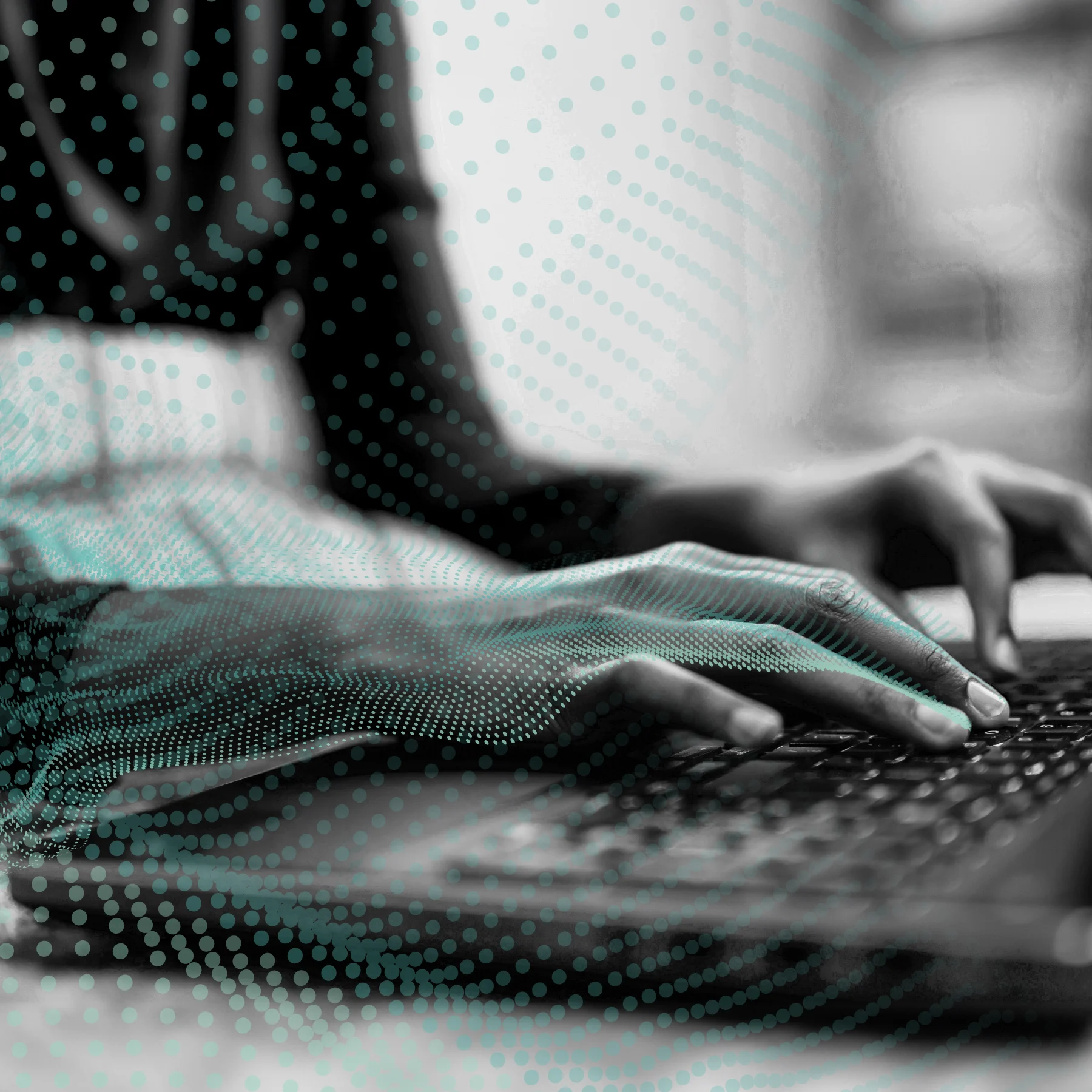 A black and white close-up of someone typing on a keyboard, with a digital overlay of turquoise dots.