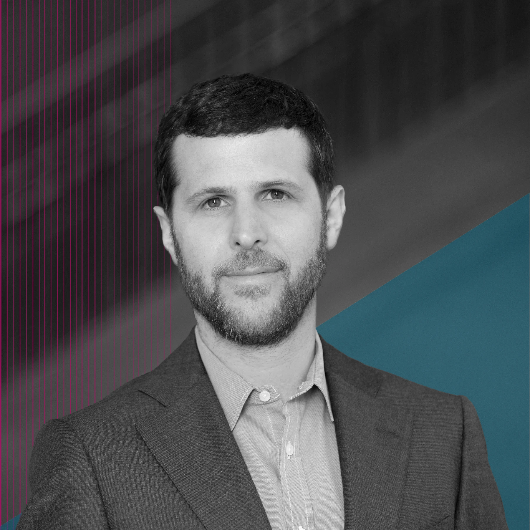 Black-and-white portrait of a man with short hair and a trimmed beard, wearing a blazer and button-down shirt. He faces the camera with a neutral expression against a background with subtle lines and teal geometric shapes.