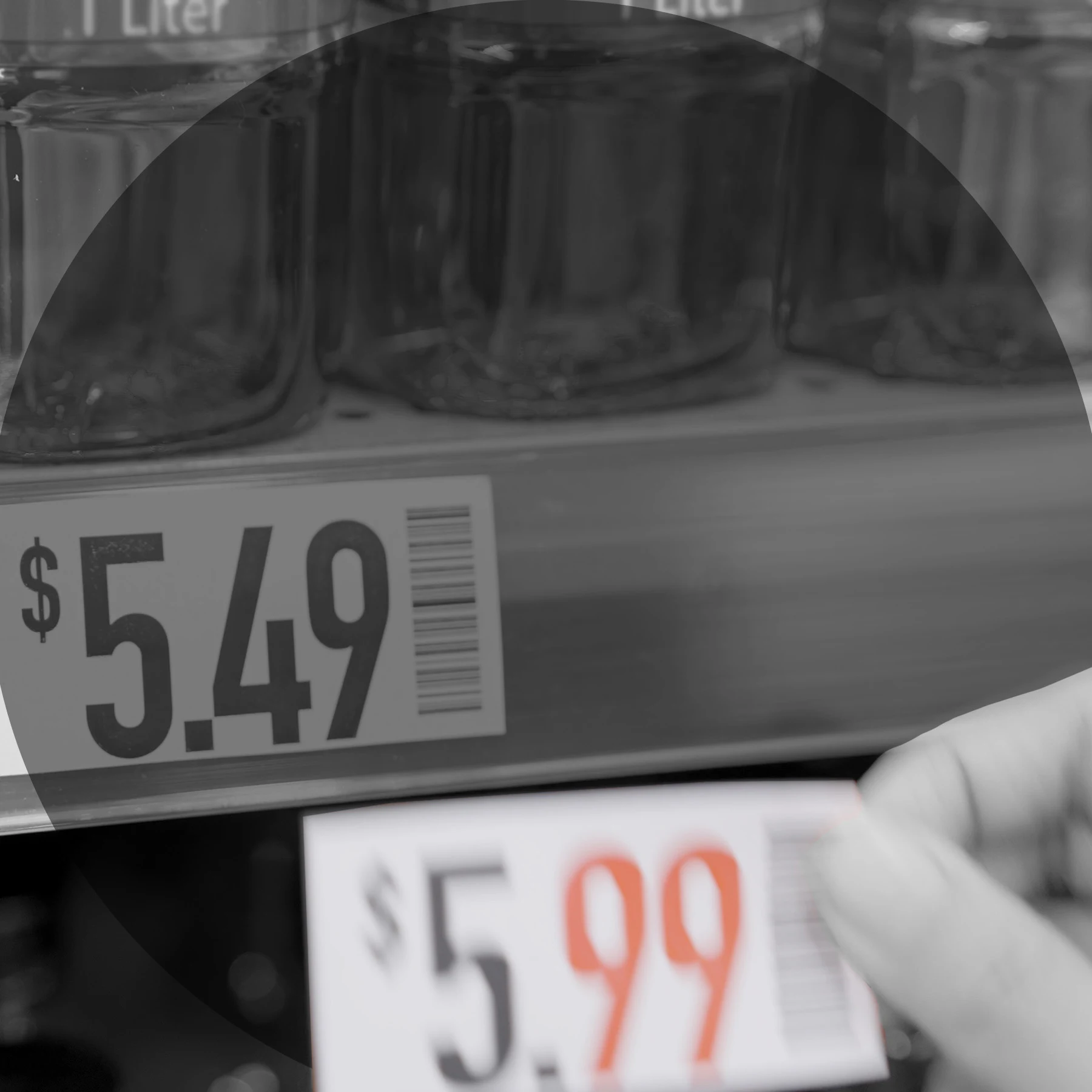 Someone replacing $5.49 price tag on shelf to one that reads $5.99