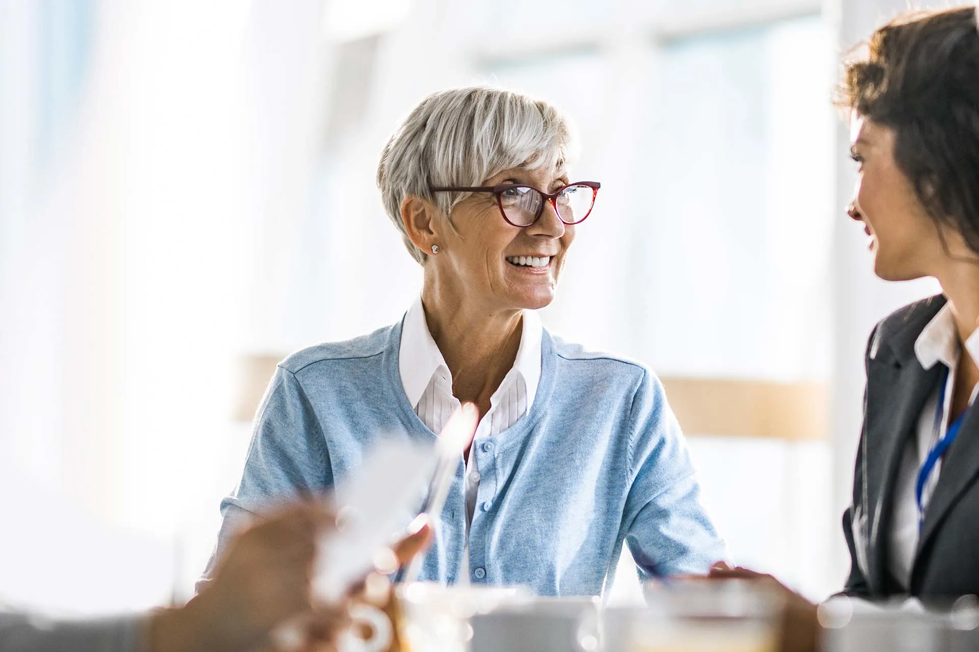 Two female executives engaged in a meeting discussion