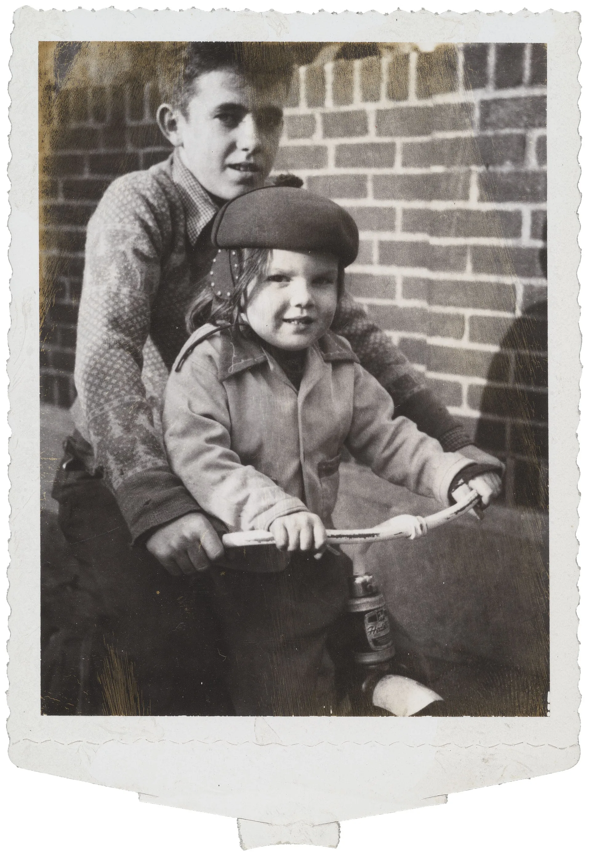 test photograph of girl and boy on bike, ca. 1950s