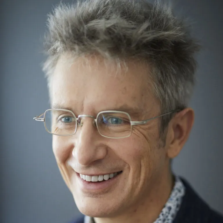 Spencer Glendon standing in front of a gray background