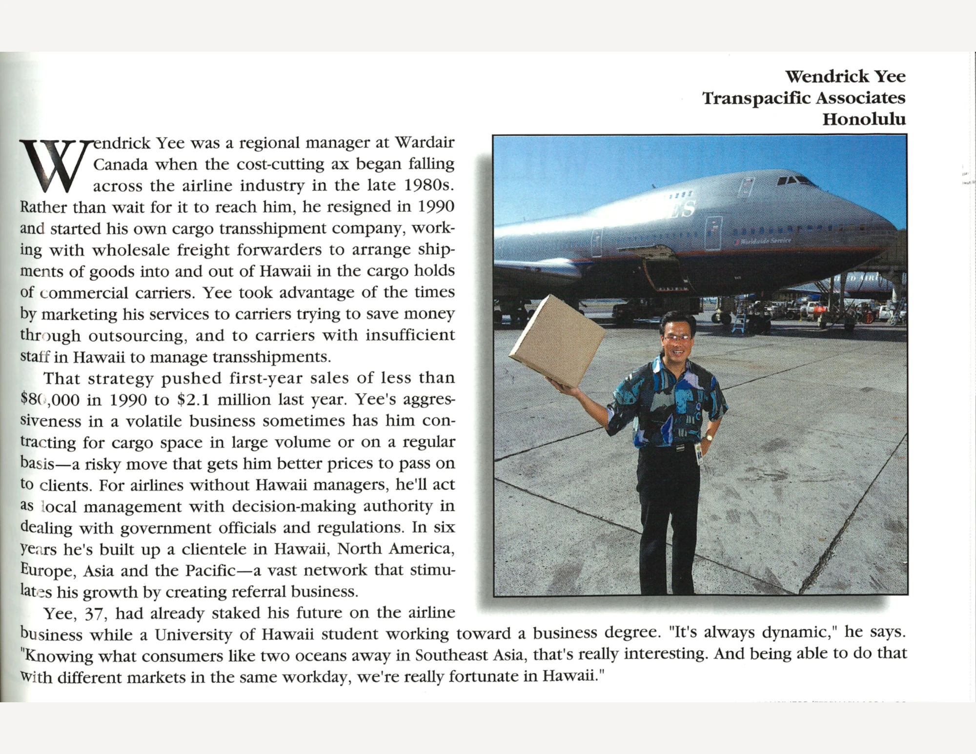 A man in a patterned shirt and black pants holding a cardboard box in one hand with a commerical plane in the background, next to text