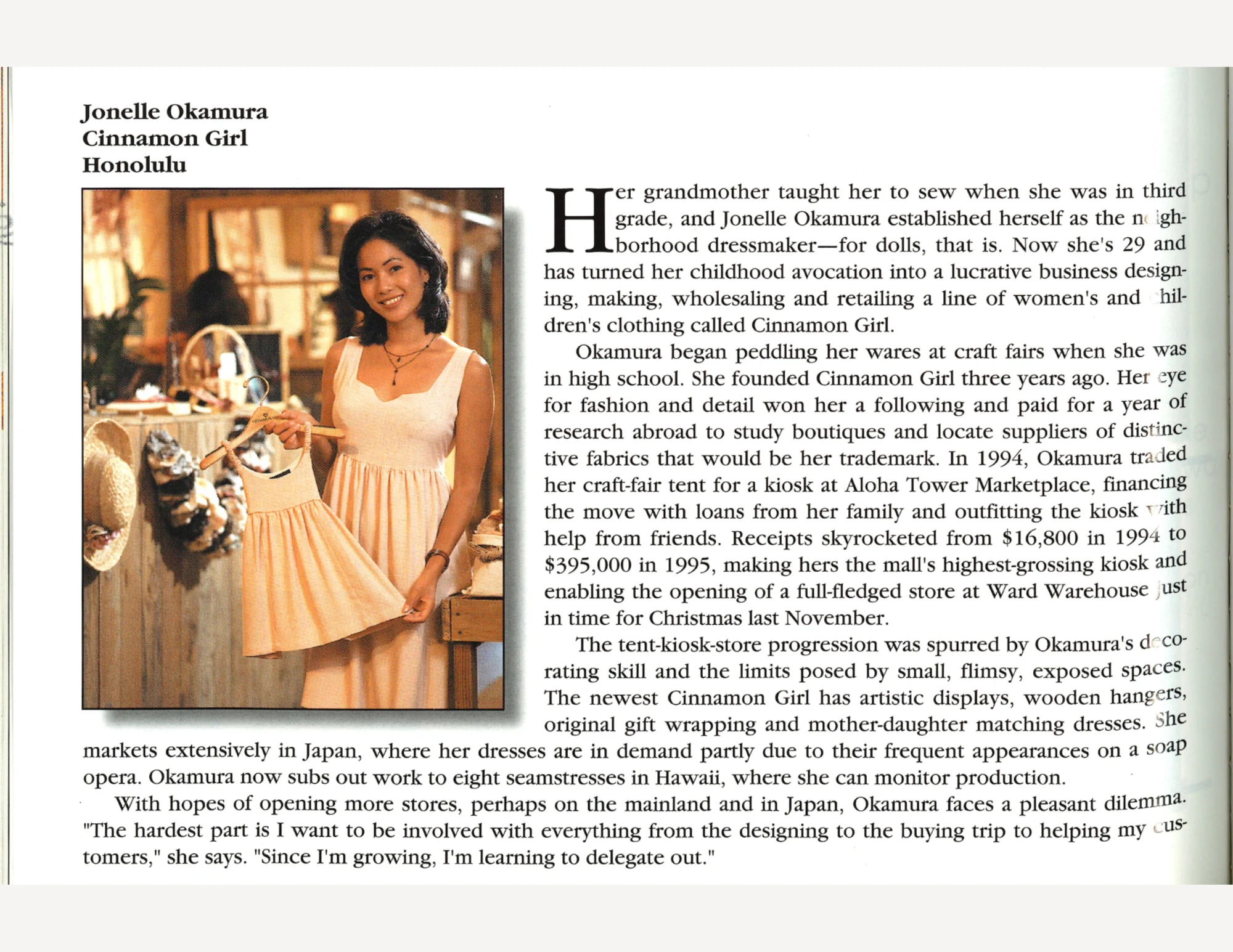 A woman in a light colored dress holding a dress of a similar and style and color but much smaller, next to text