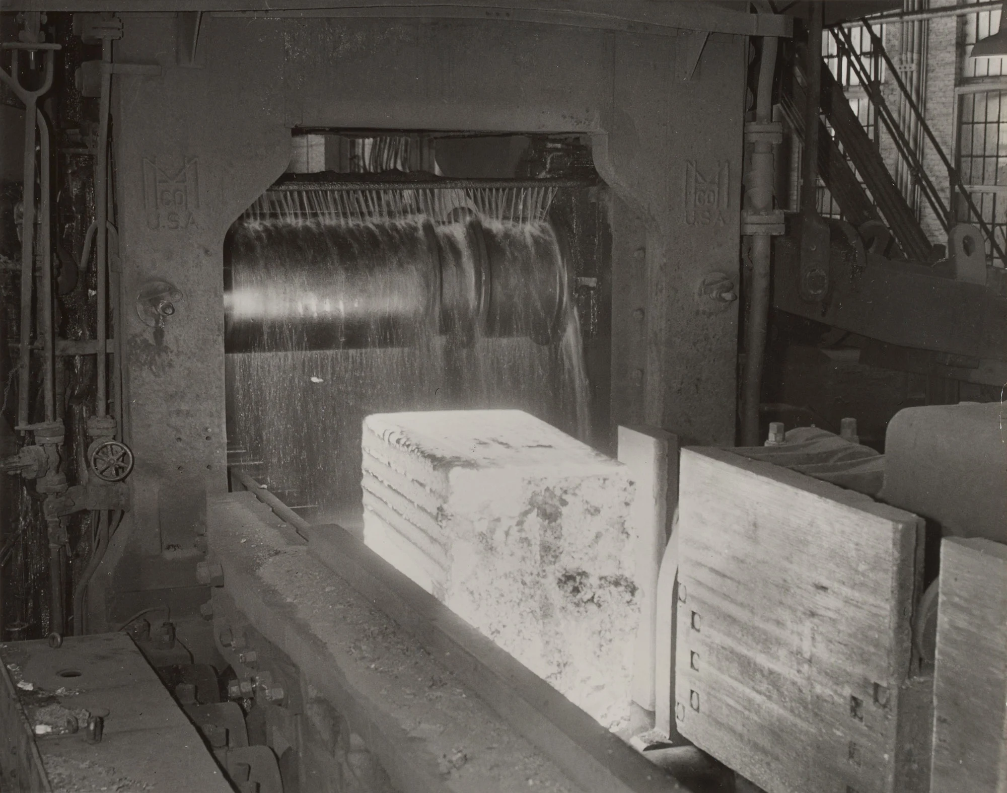 Glowing 12-ton steel ingot enters rolls of 44-inch blooming mill at Gary Steel Works.