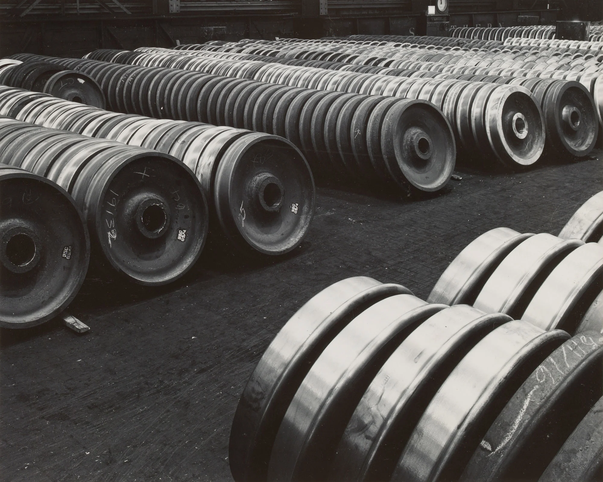 Rows of finished railroad car wheels await shipment at the wheel mill of Gary Steel Works.