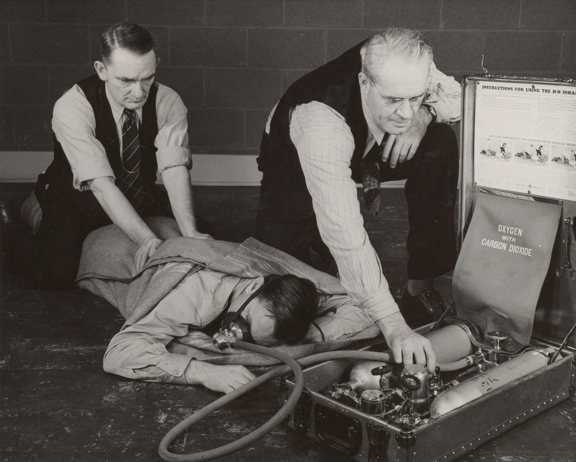 Inhalator squad practices resuscitation with oxygen unit and prone pressure method at Gary Steel Works.