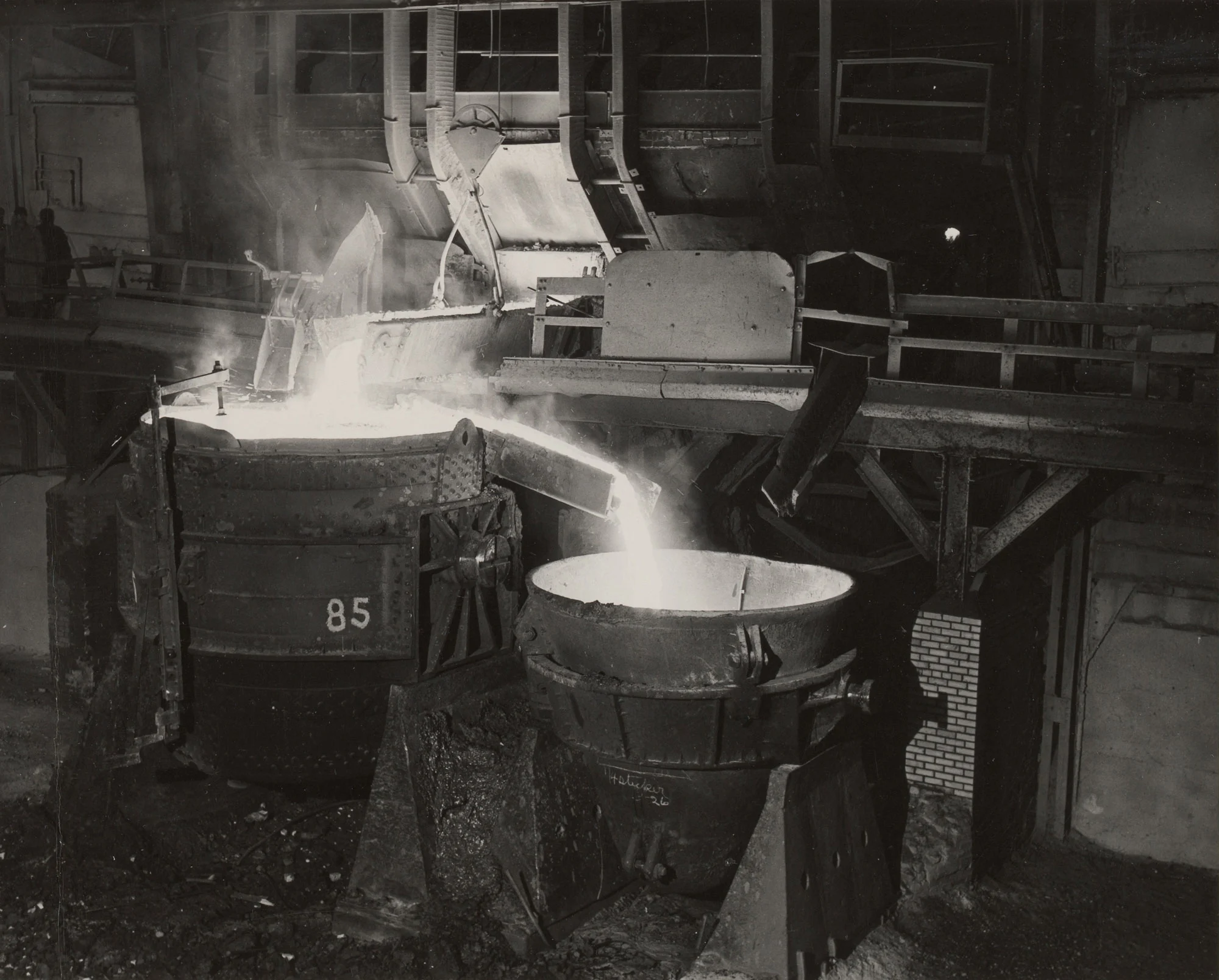 Molten steel flows from open hearth furnace into ladle, with slag overflowing into thimble at Gary Steel Works.