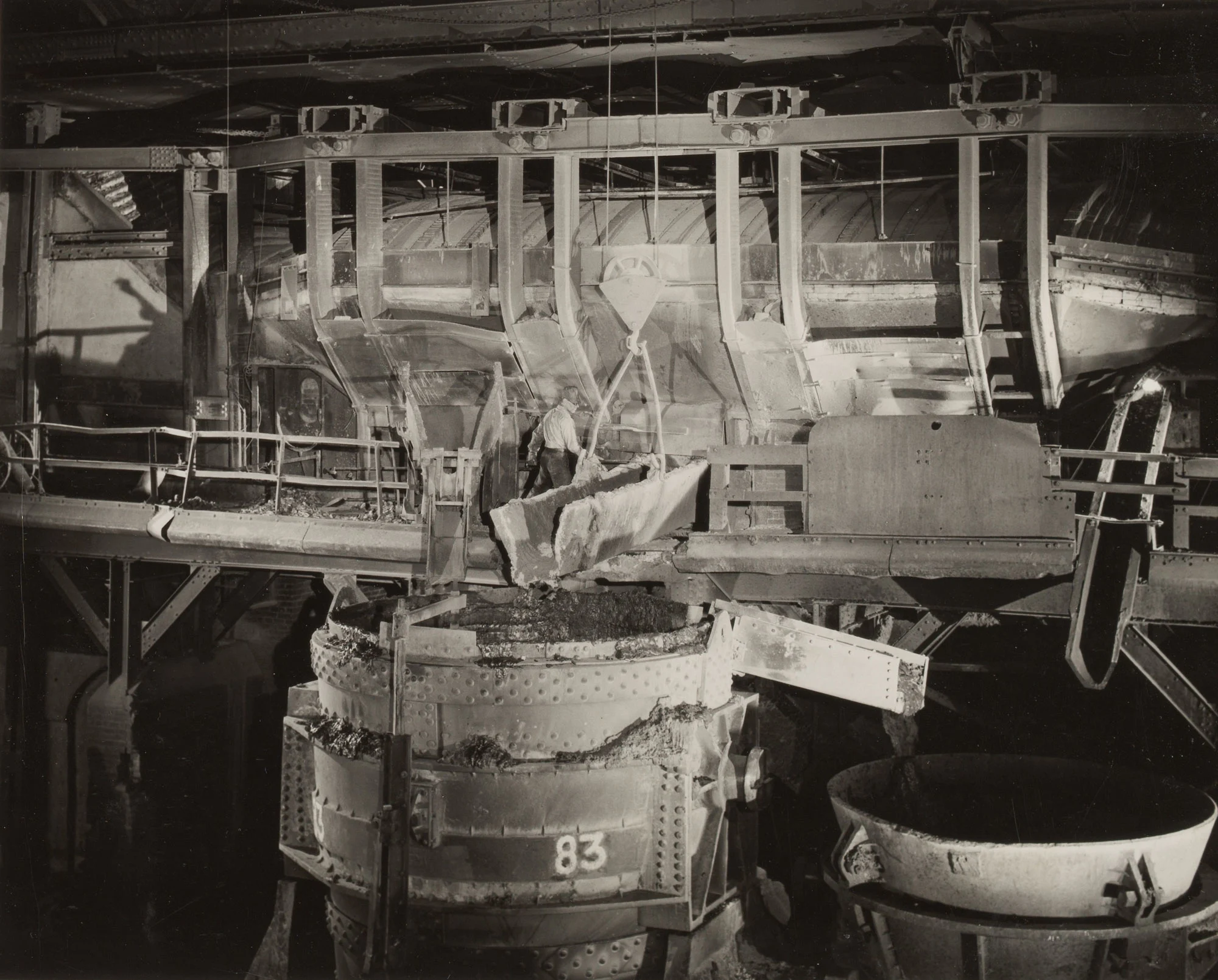 Worker burns out plug to prepare open hearth furnace No. 83 for tapping at Gary Steel Works.