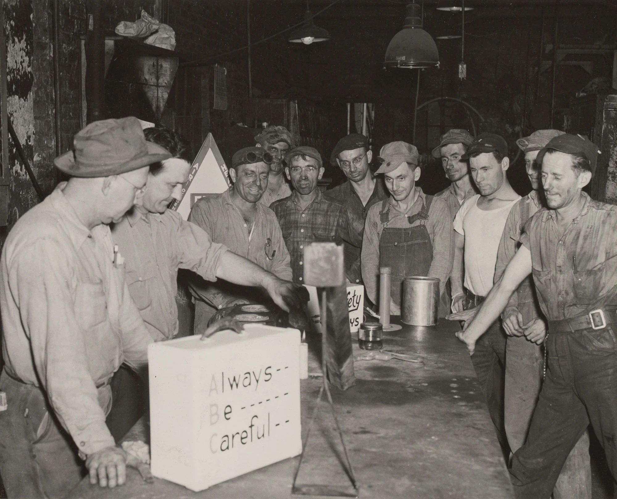 Assistant fire chief demonstrates gasoline fume behavior to open hearth workers at Gary Steel Works.
