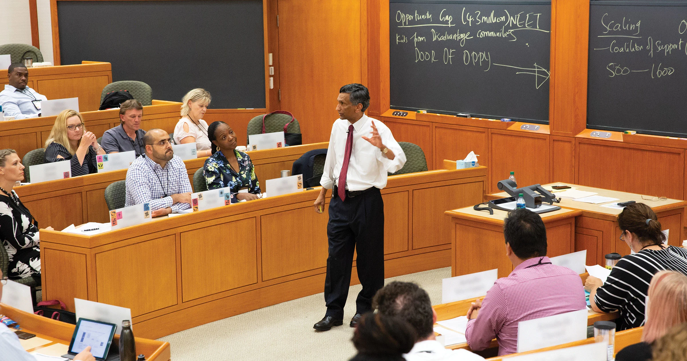 Faculty presents in front of board during lecture