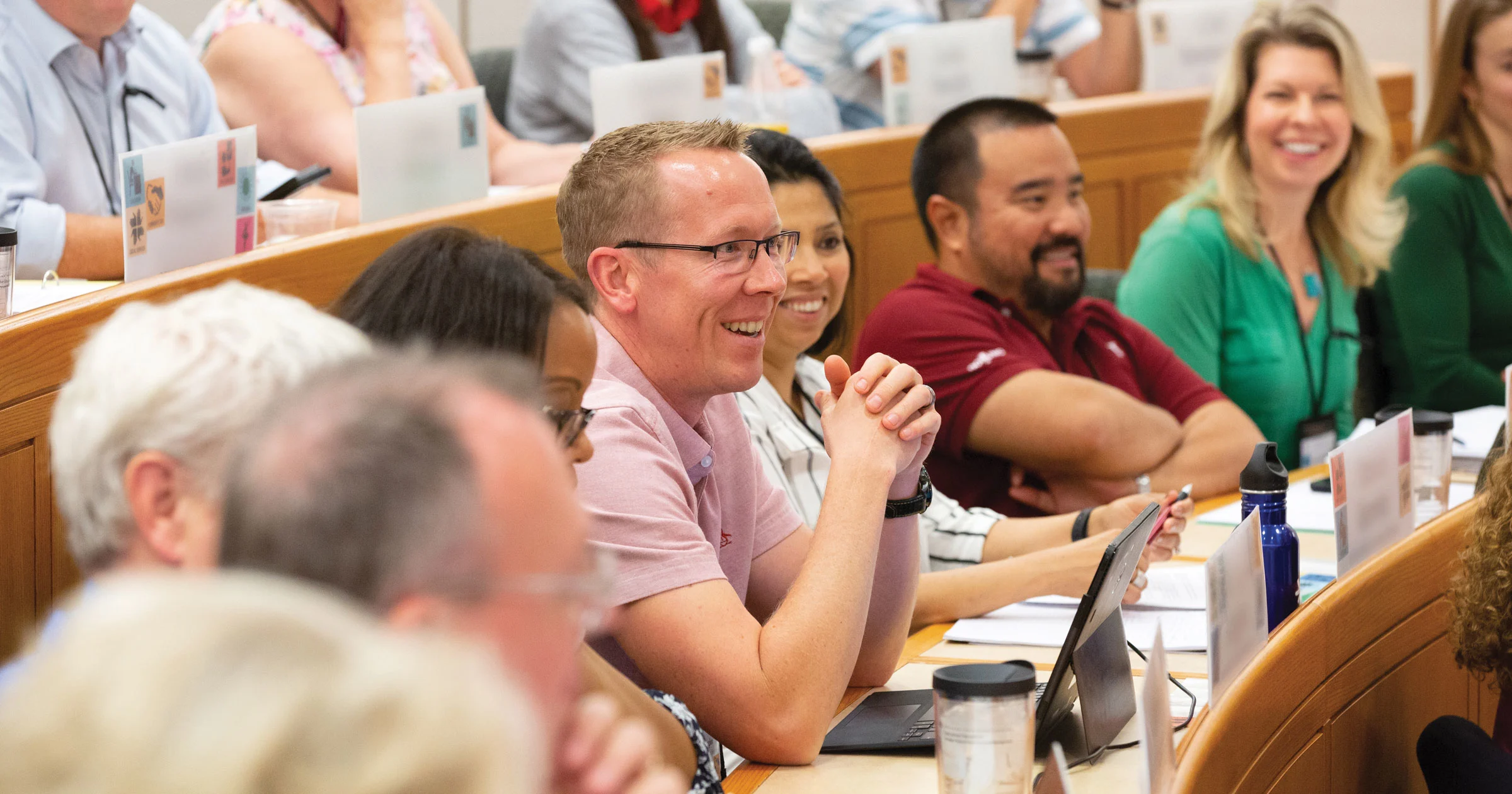 Executive participates in class discussion as fellow students actively listen
