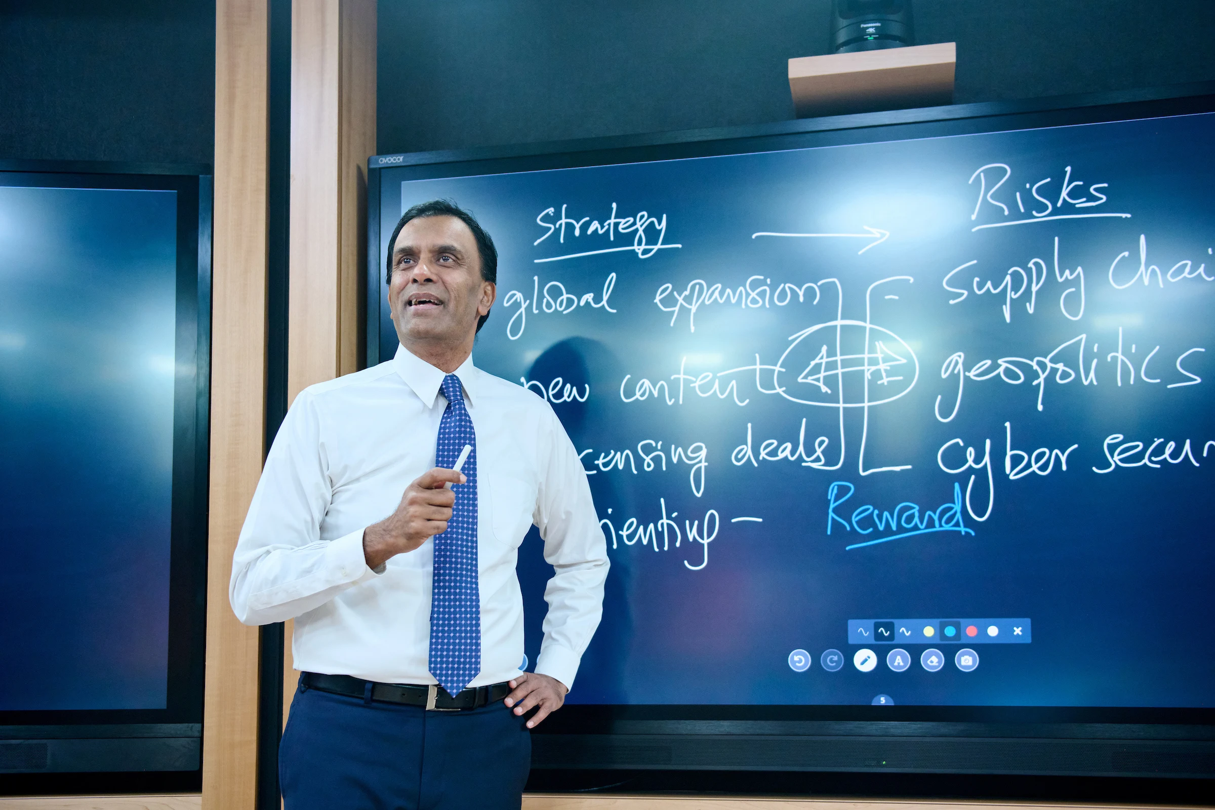 HBS professor in front of a digital board in the Live Online Classroom