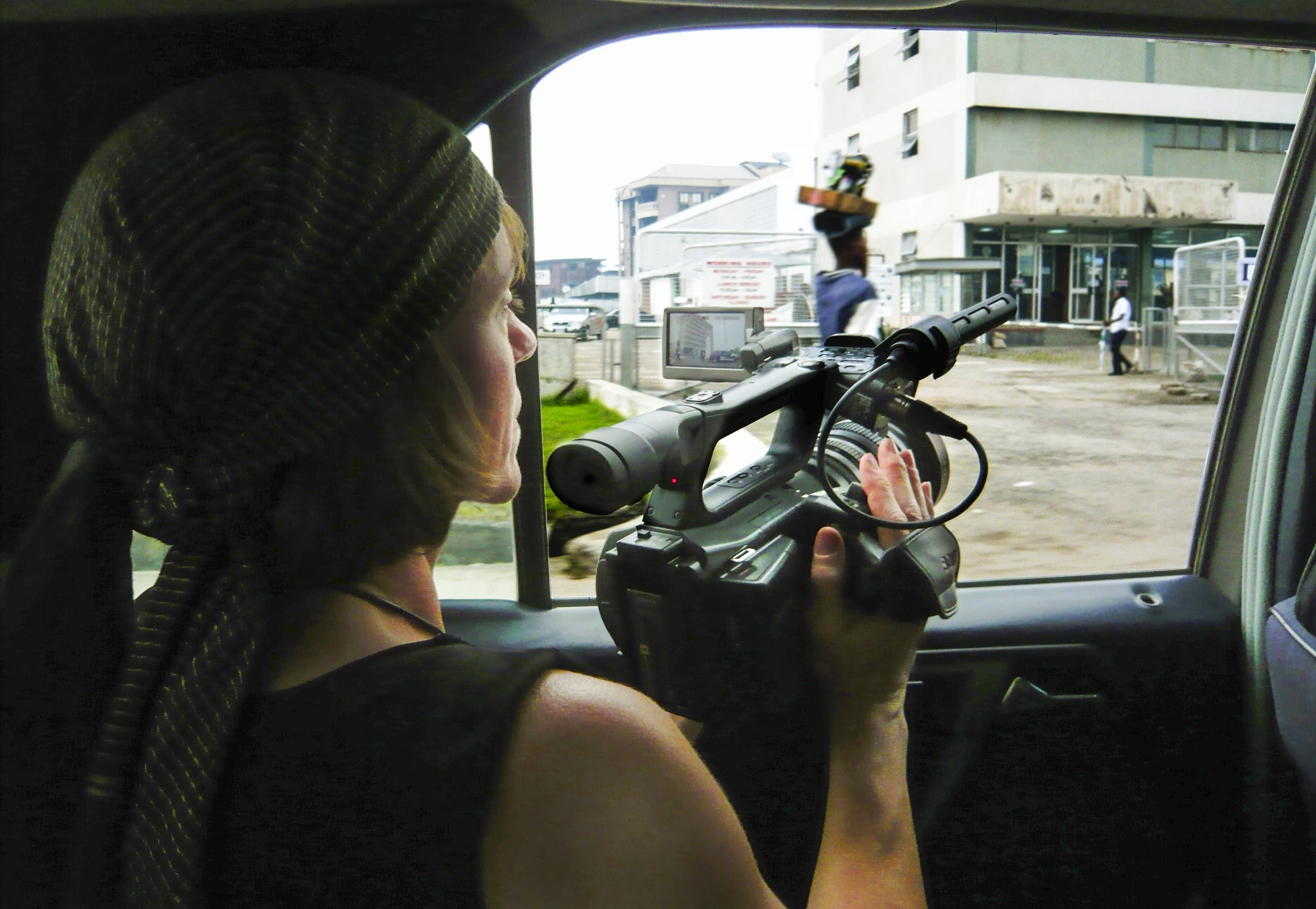 Ruth filming from a car window.