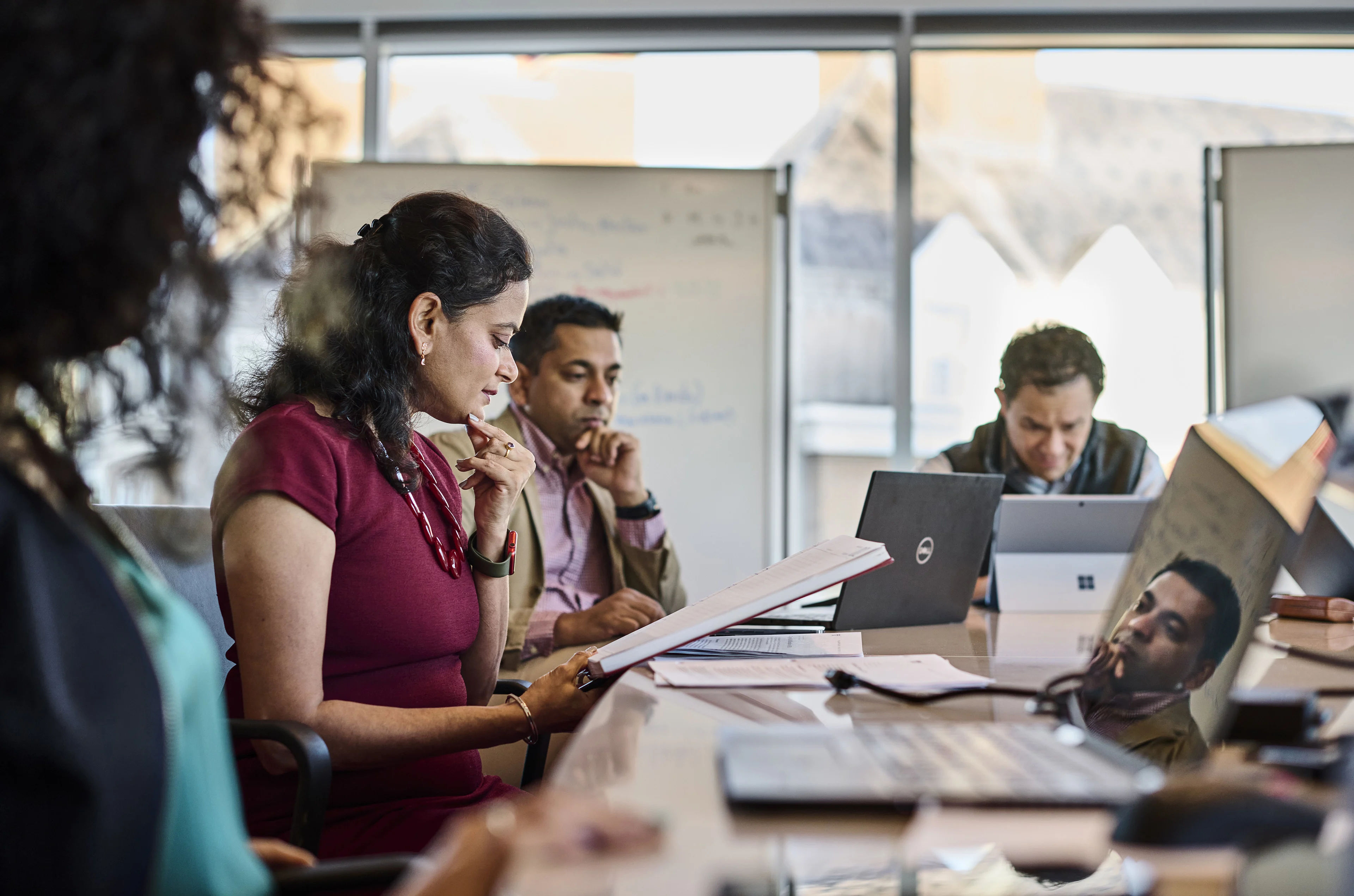 Executives in group discussion in living group in a conference room 