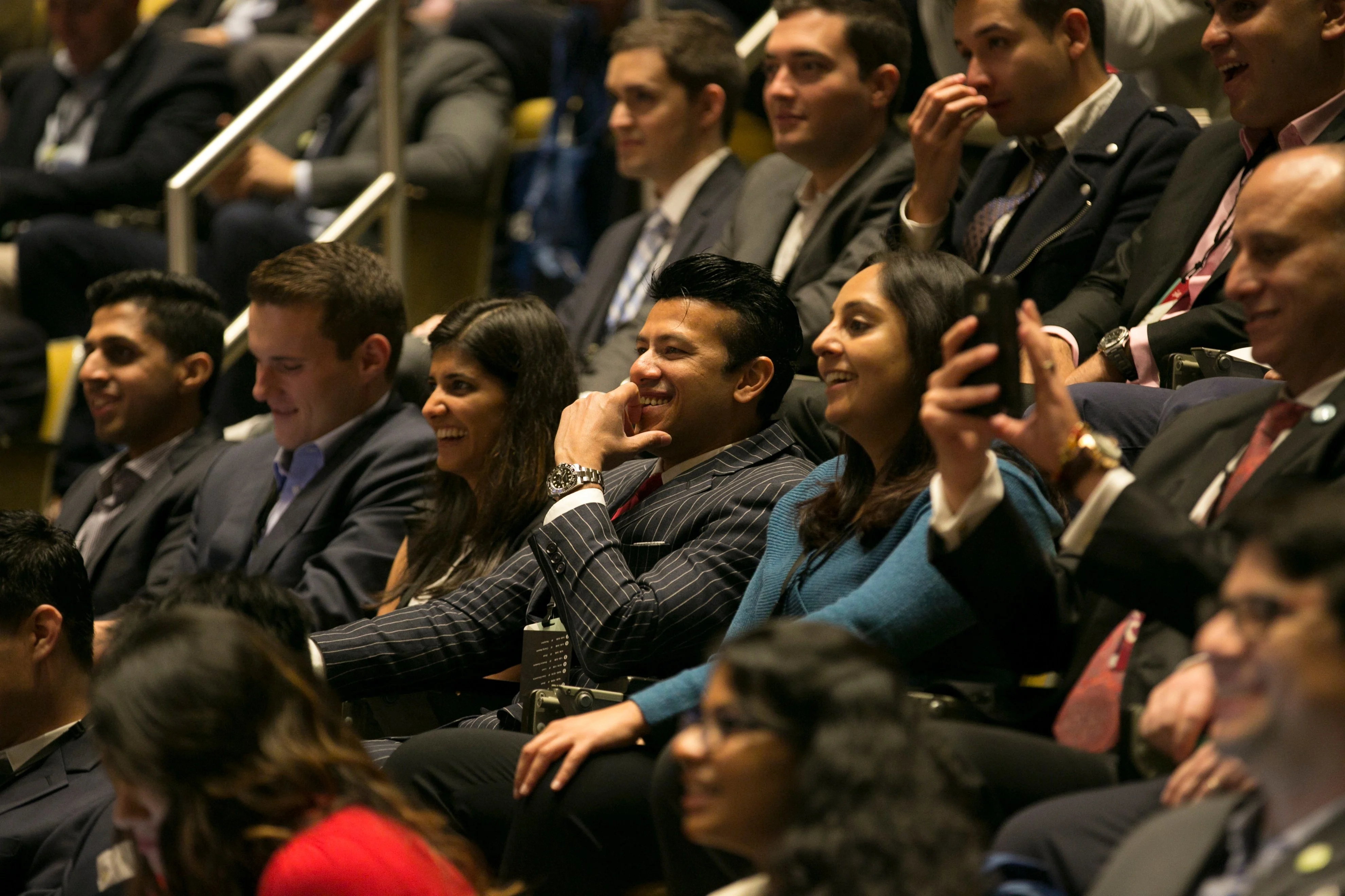 Students laugh during the morning keynote session at HBX ConneXt