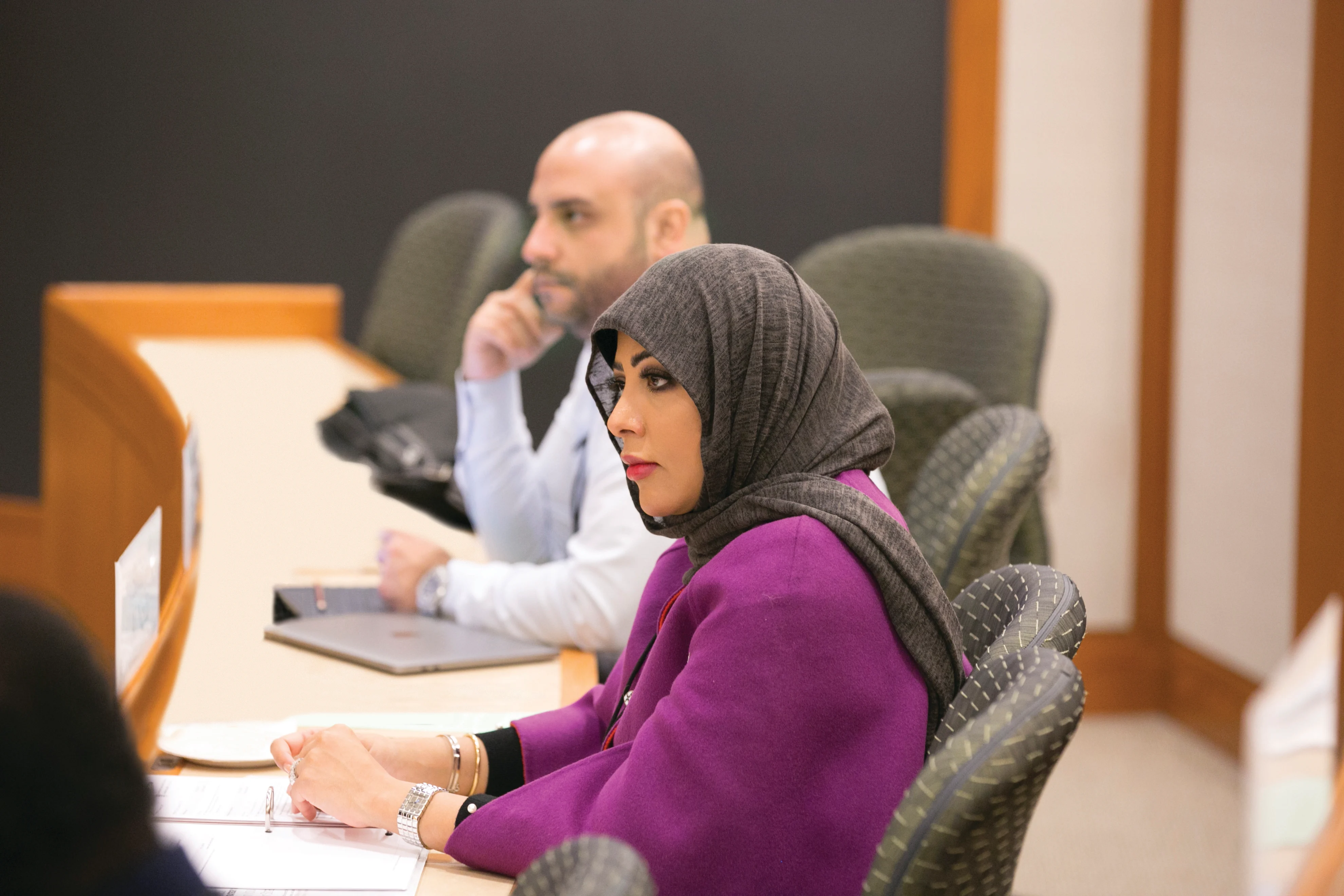 Female and male executives listen carefully the lecture