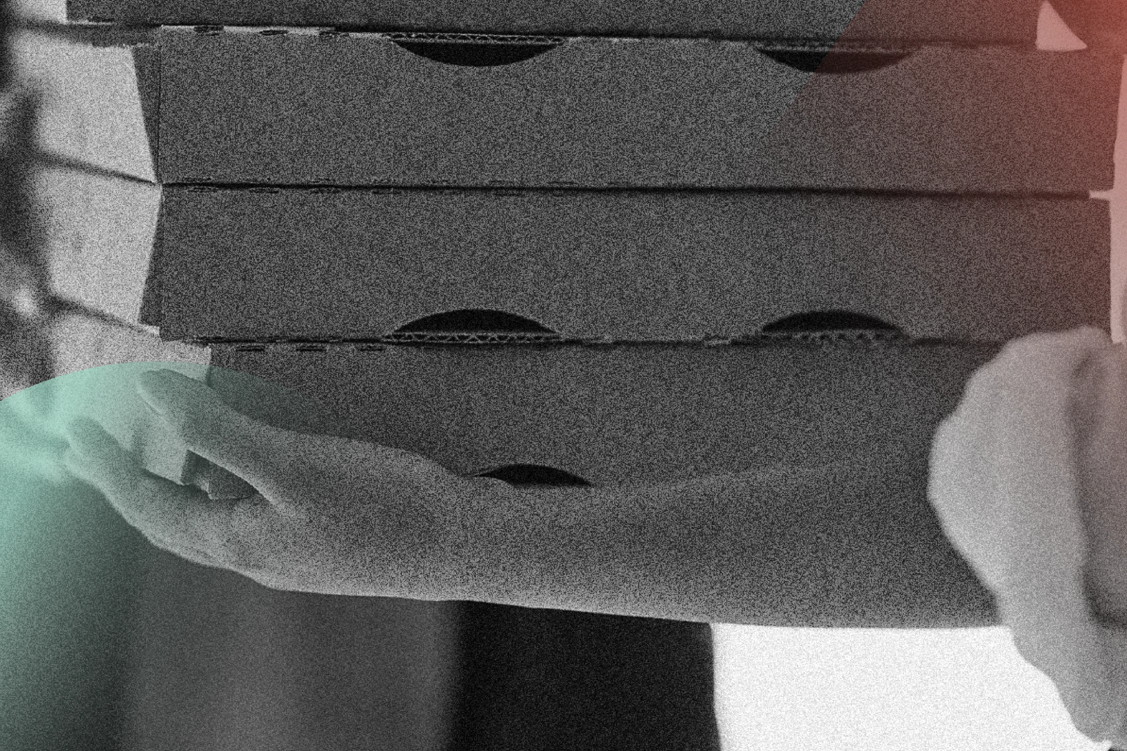 Black and white image with woman collecting pizza box from delivery person.
