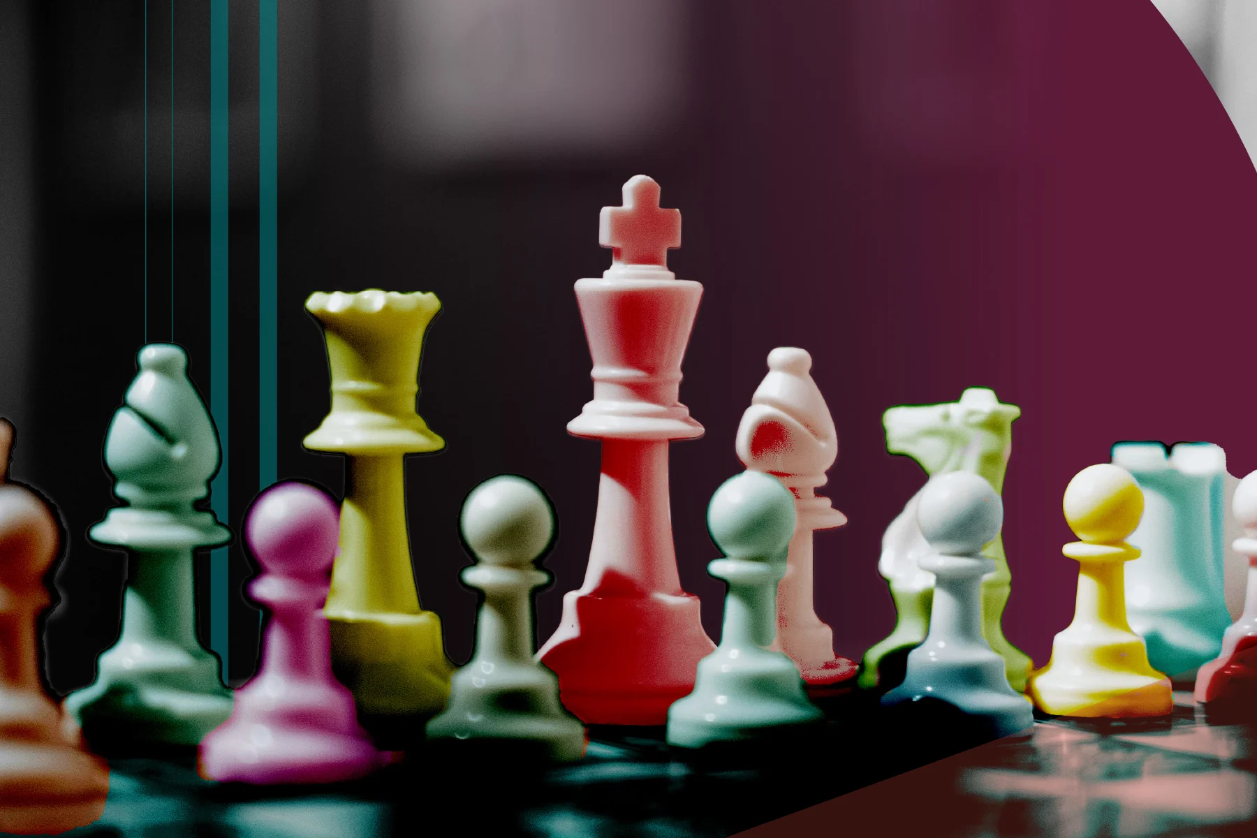 Colorful chess pieces on a chessboard with king in the center. The background is dark with a maroon overlay on the right side.