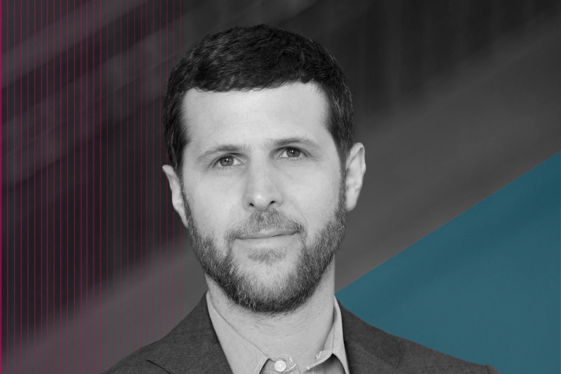 Black-and-white portrait of a man with short hair and a trimmed beard, wearing a blazer and button-down shirt. He faces the camera with a neutral expression against a background with subtle lines and teal geometric shapes.