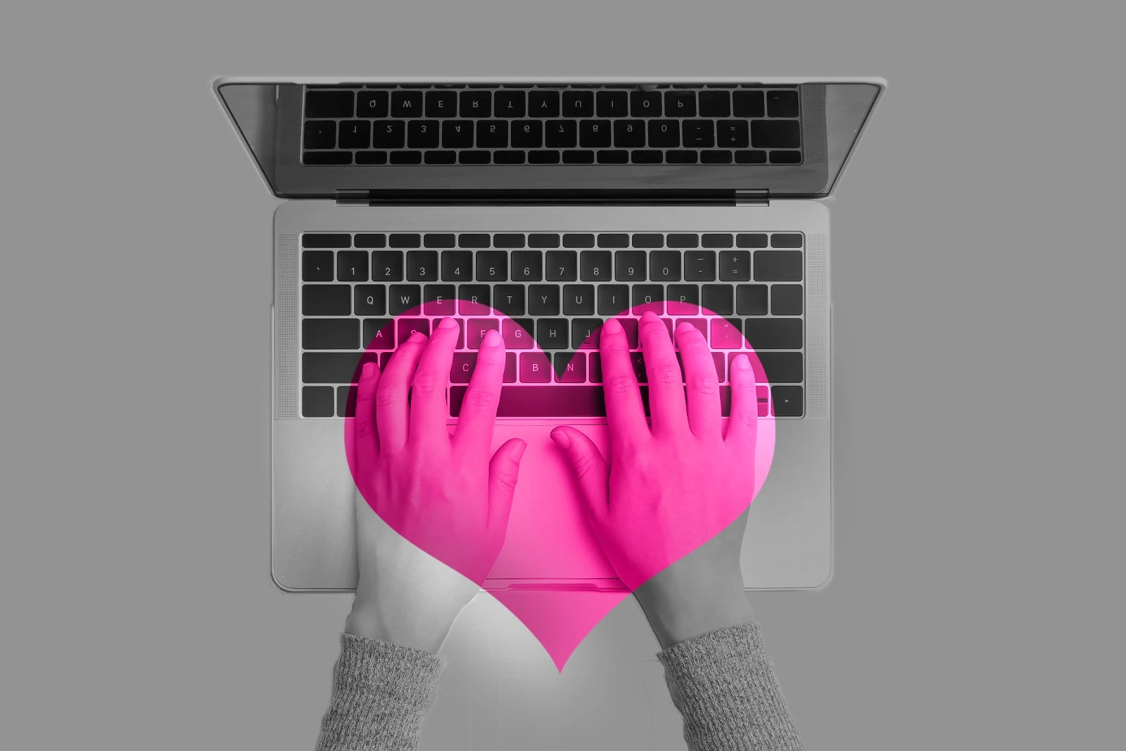Hands over keyboard keys in black and gray, with pink heart overlay.