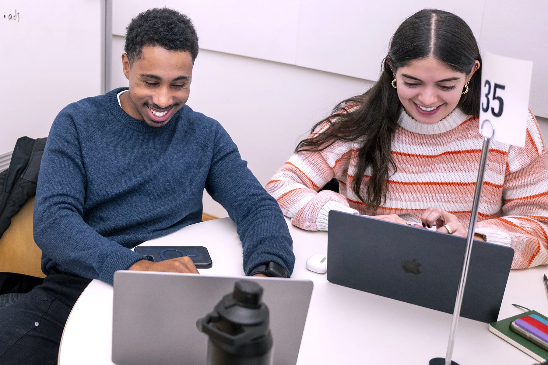 Two MBA students team up at a hackathon Short Intensive Program in Batten Hall.