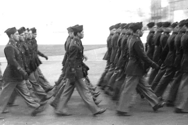 HBS students in military uniforms training outdoors in formation, 1943 wartime setting.