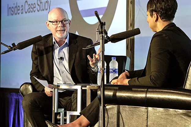 Two people seated with microphones taping a Cold Call Podcast episode, circa 2015.