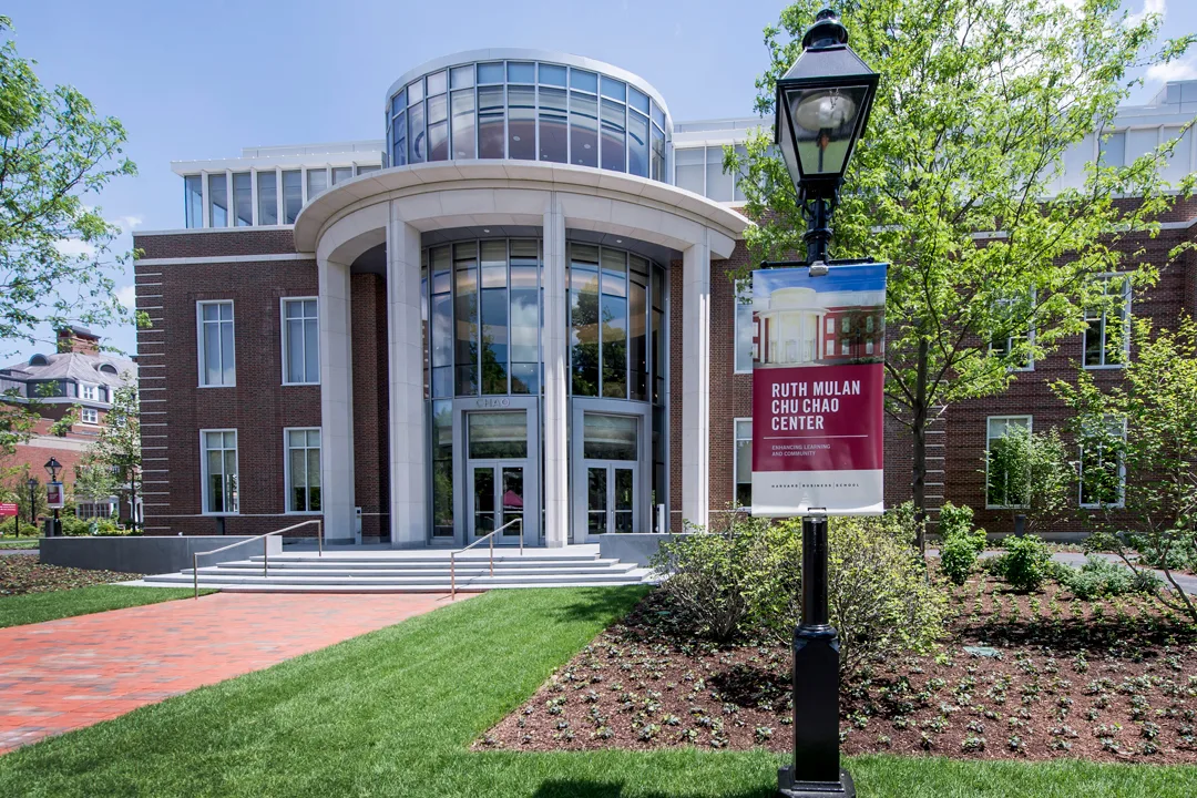 Main outside entrance of the Chao Center with a banner on a lamp post in the foreground that says Ruth Mulan Chu Chao Center, Enhancing Learning and Community 