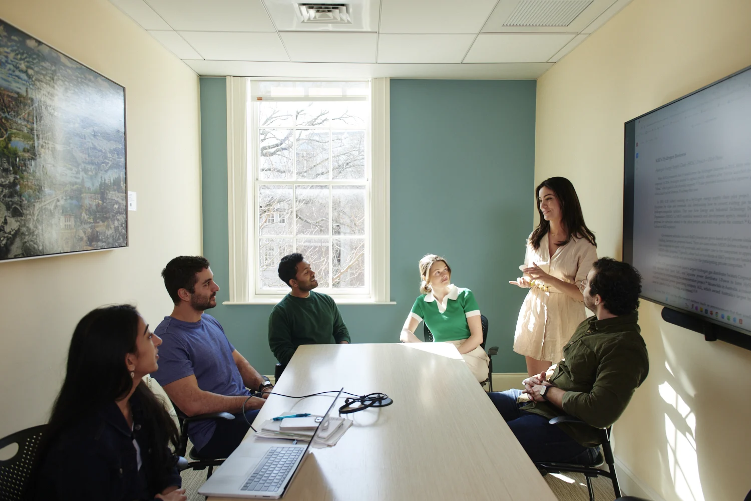 Several students around a table with monitor in Baker 379