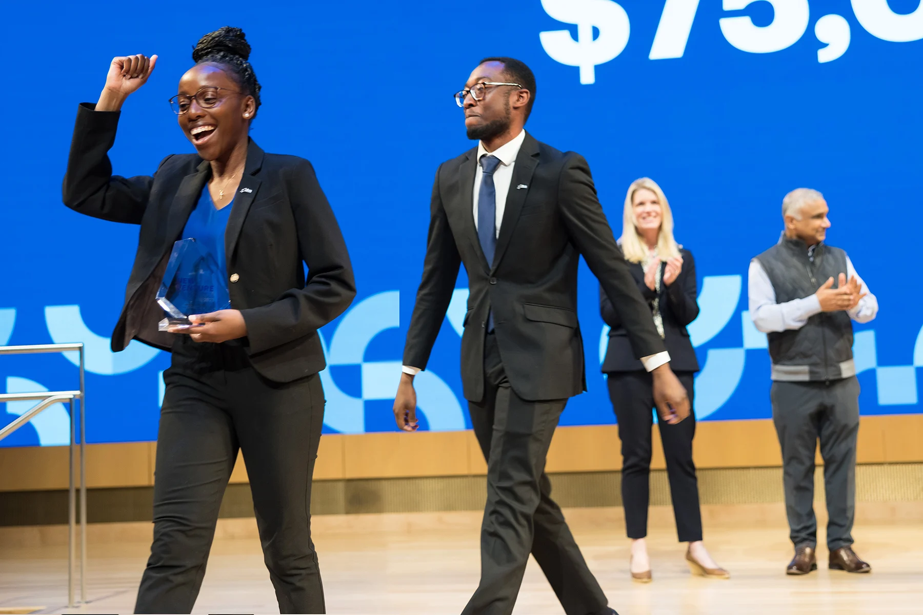 Winners of the 2023 Social Enterprise Track of the New Venture Competition accept their trophy.